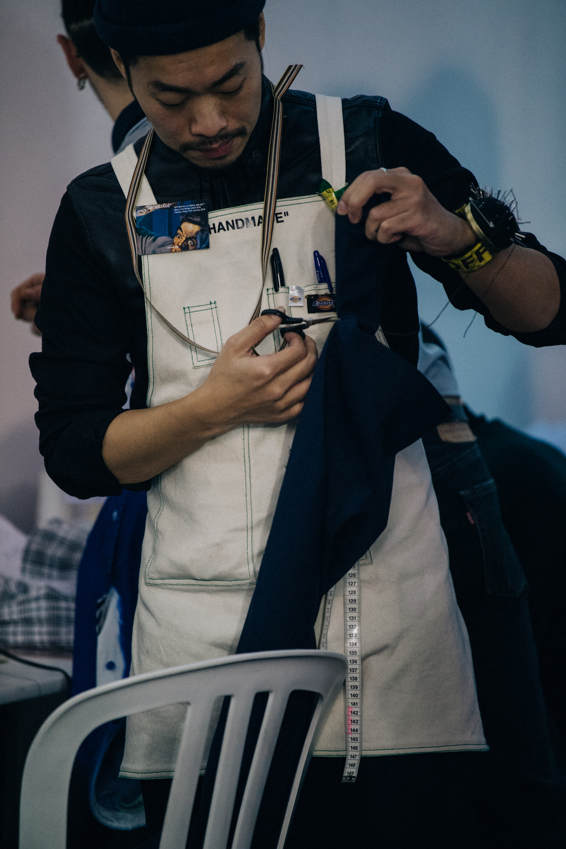 Man wearing Off-White apron backstage