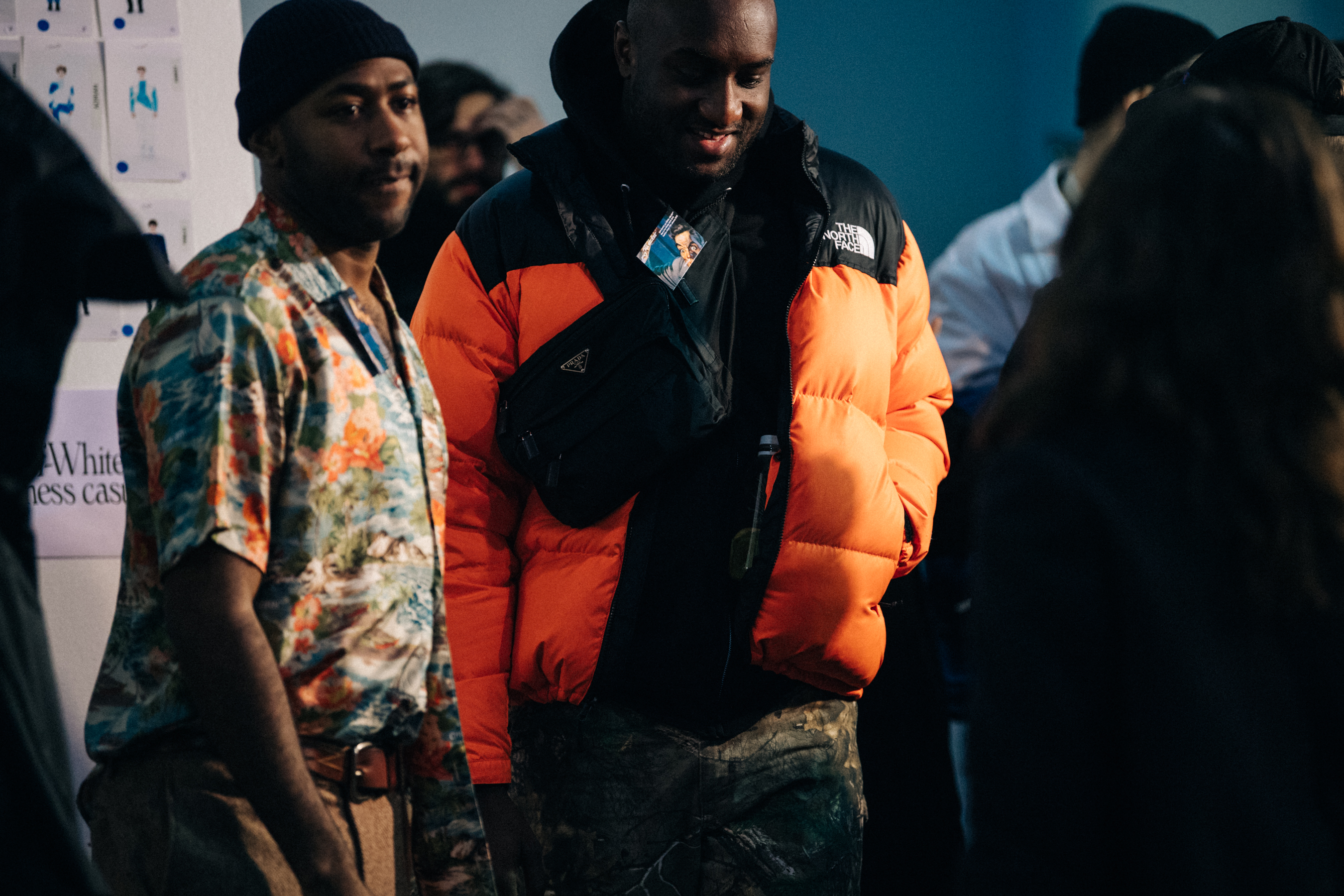 Virgil Abloh wearing orange coat backstage