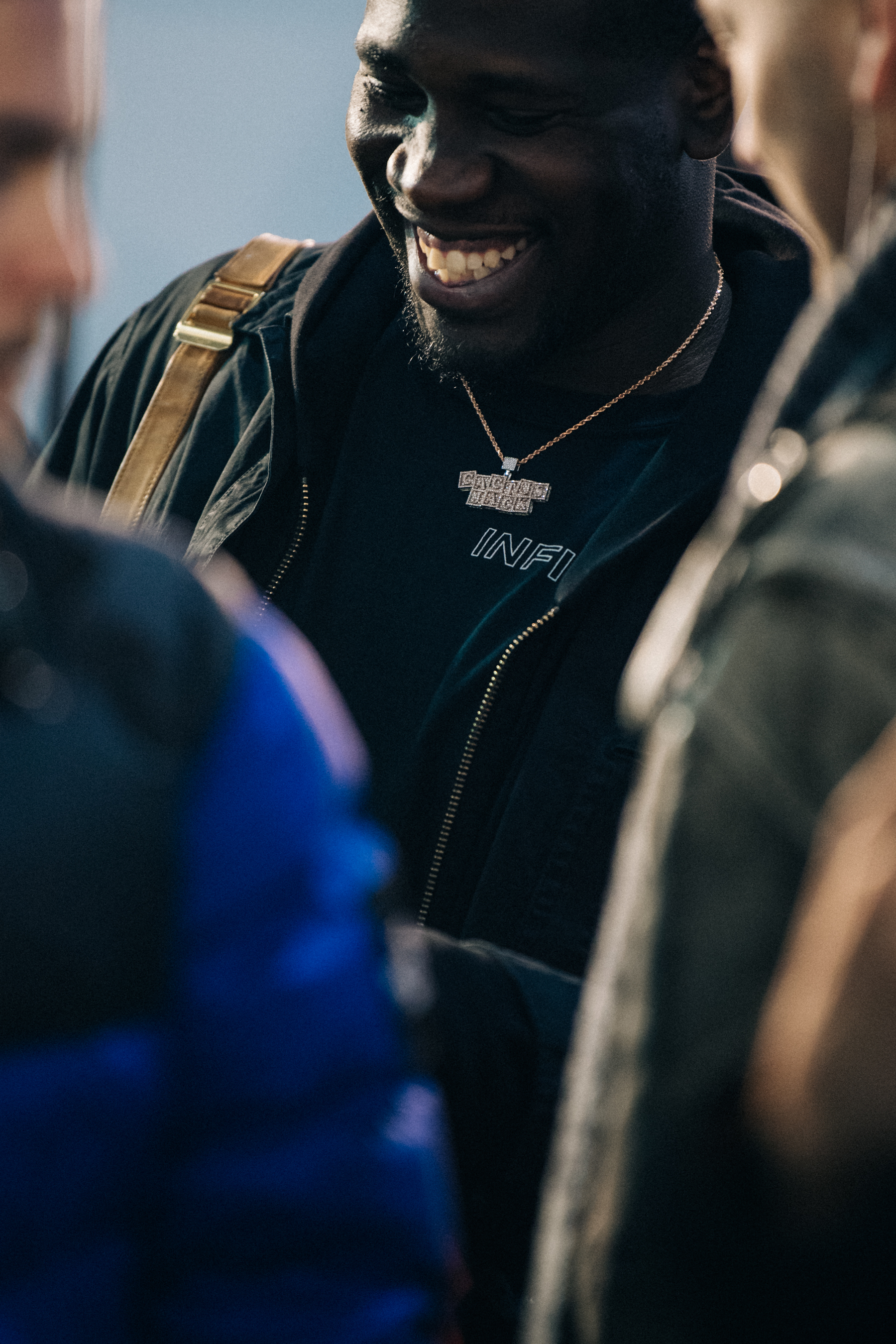 Man backstage wearing gold necklace