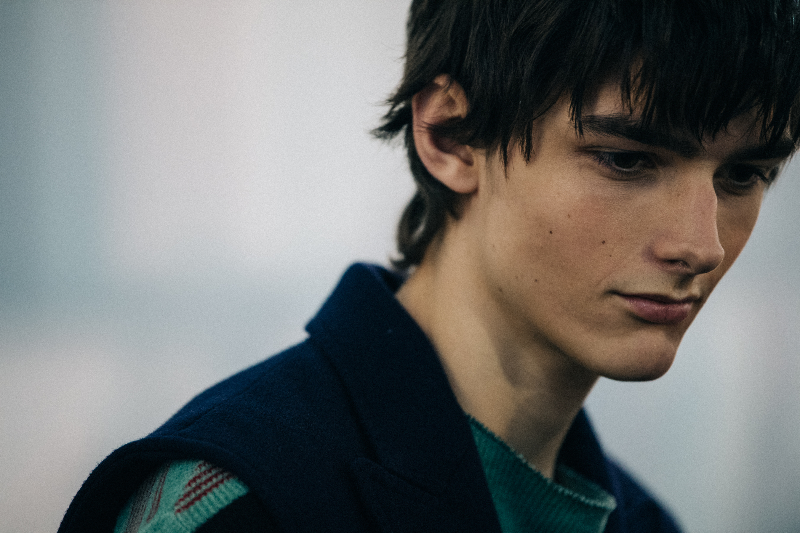 Model wearing green jumper backstage