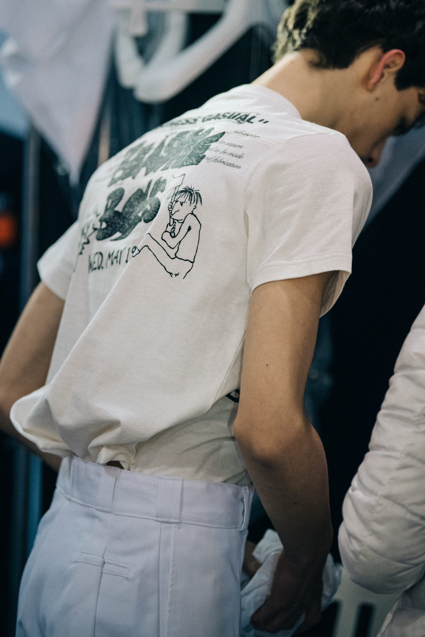 Model wearing white shirt backstage