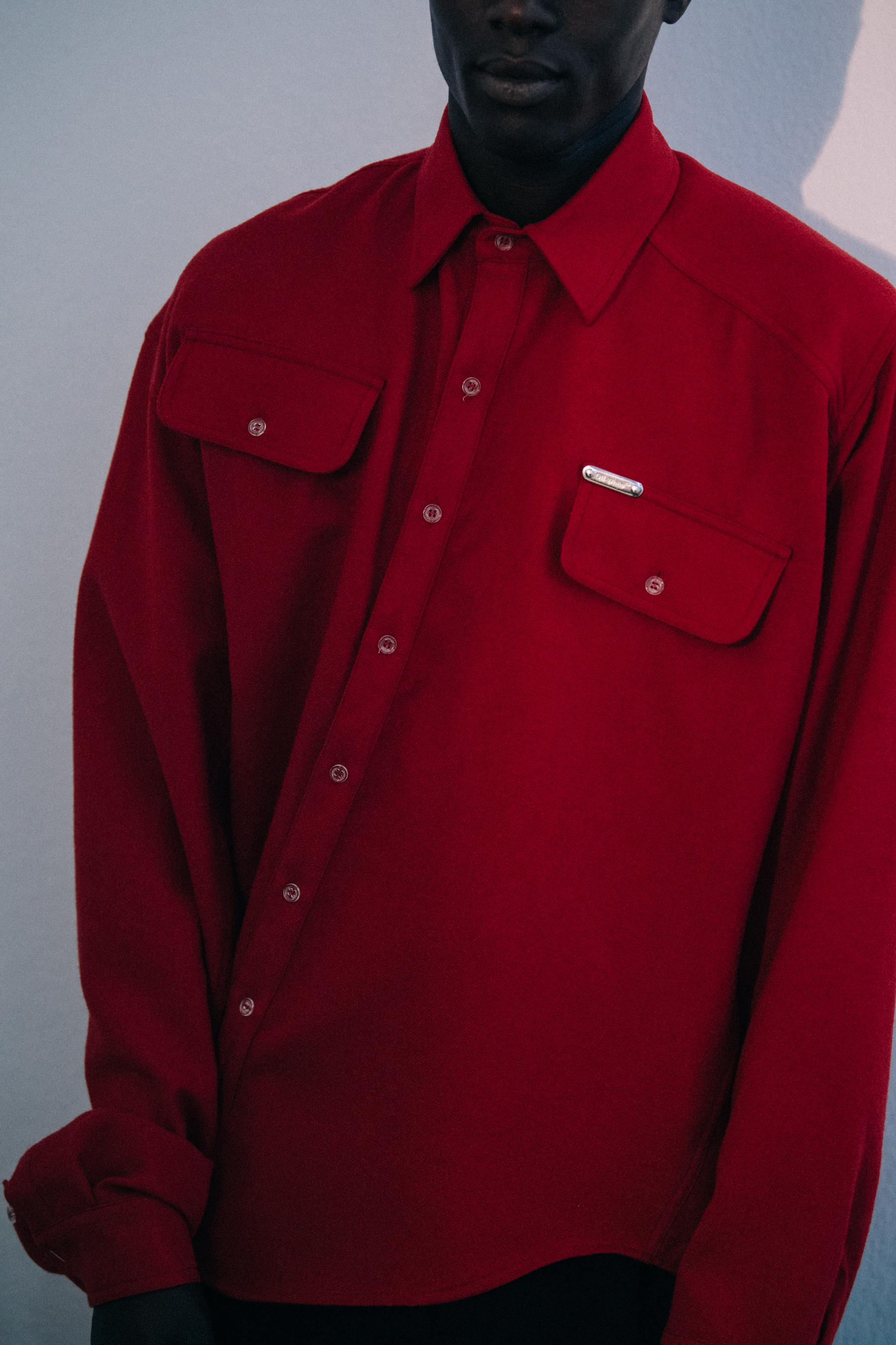 Alpha Dia wearing red Off-White shirt