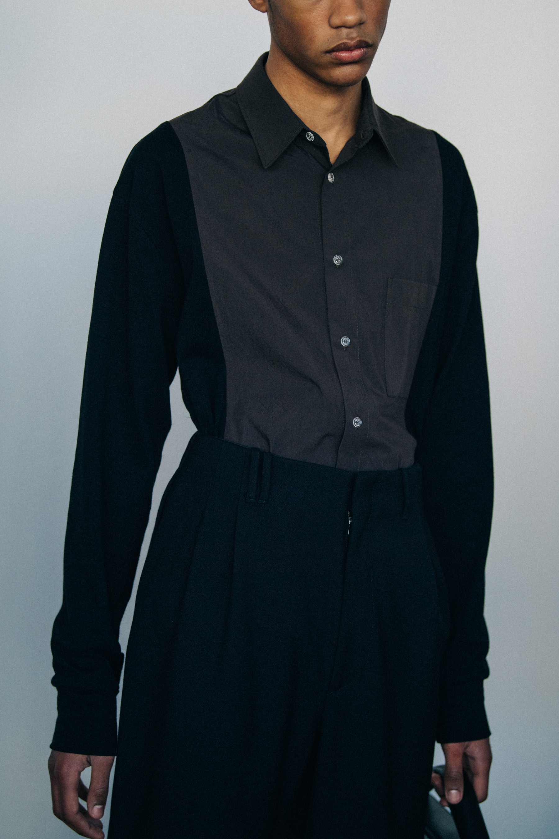 Model wearing black and grey shirt
