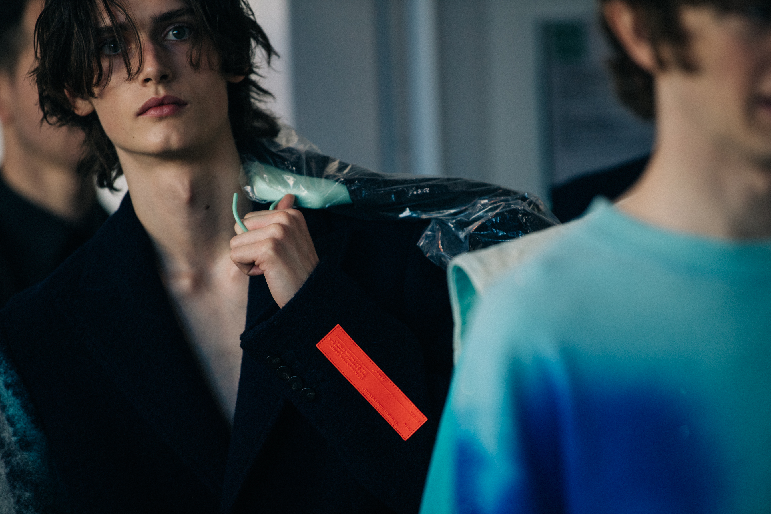 Model carrying coat over shoulder