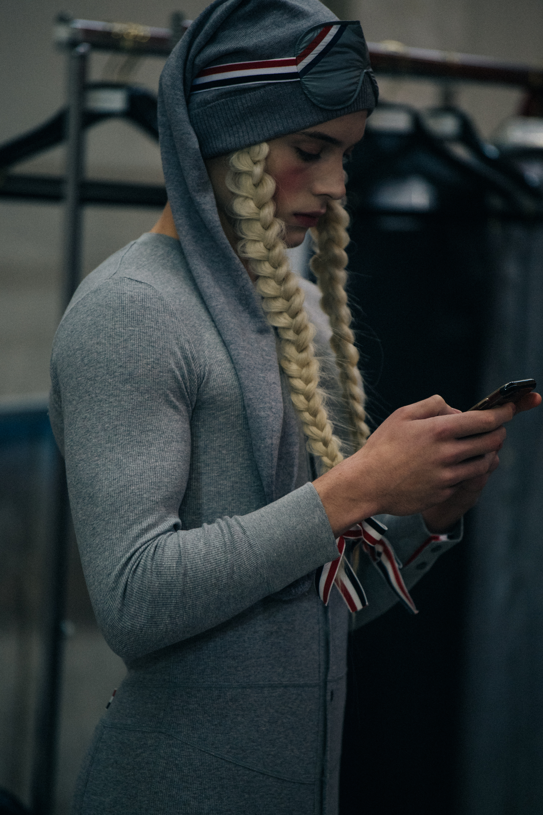 Model wearing grey with pigtails
