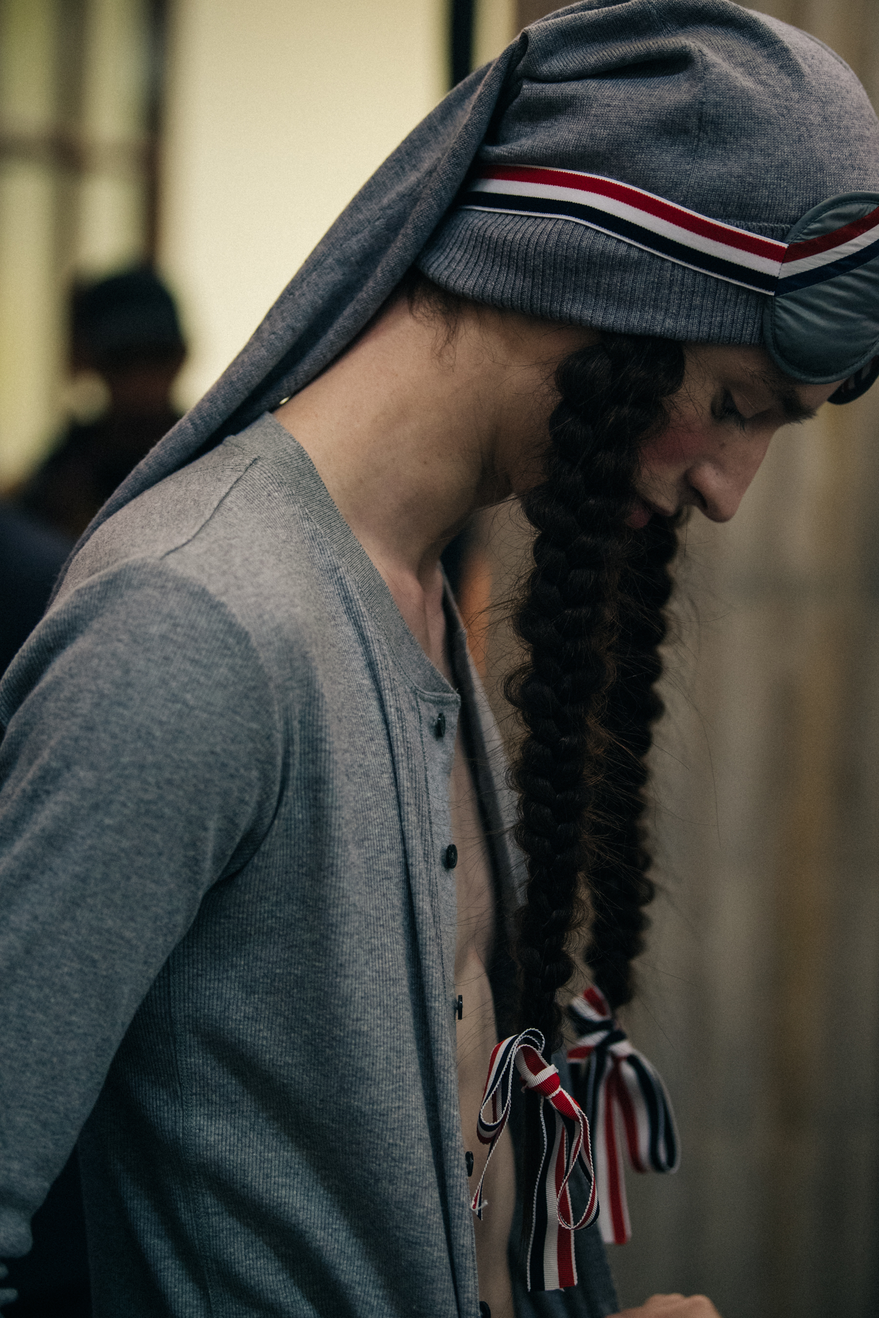 Model wearing grey with pigtails