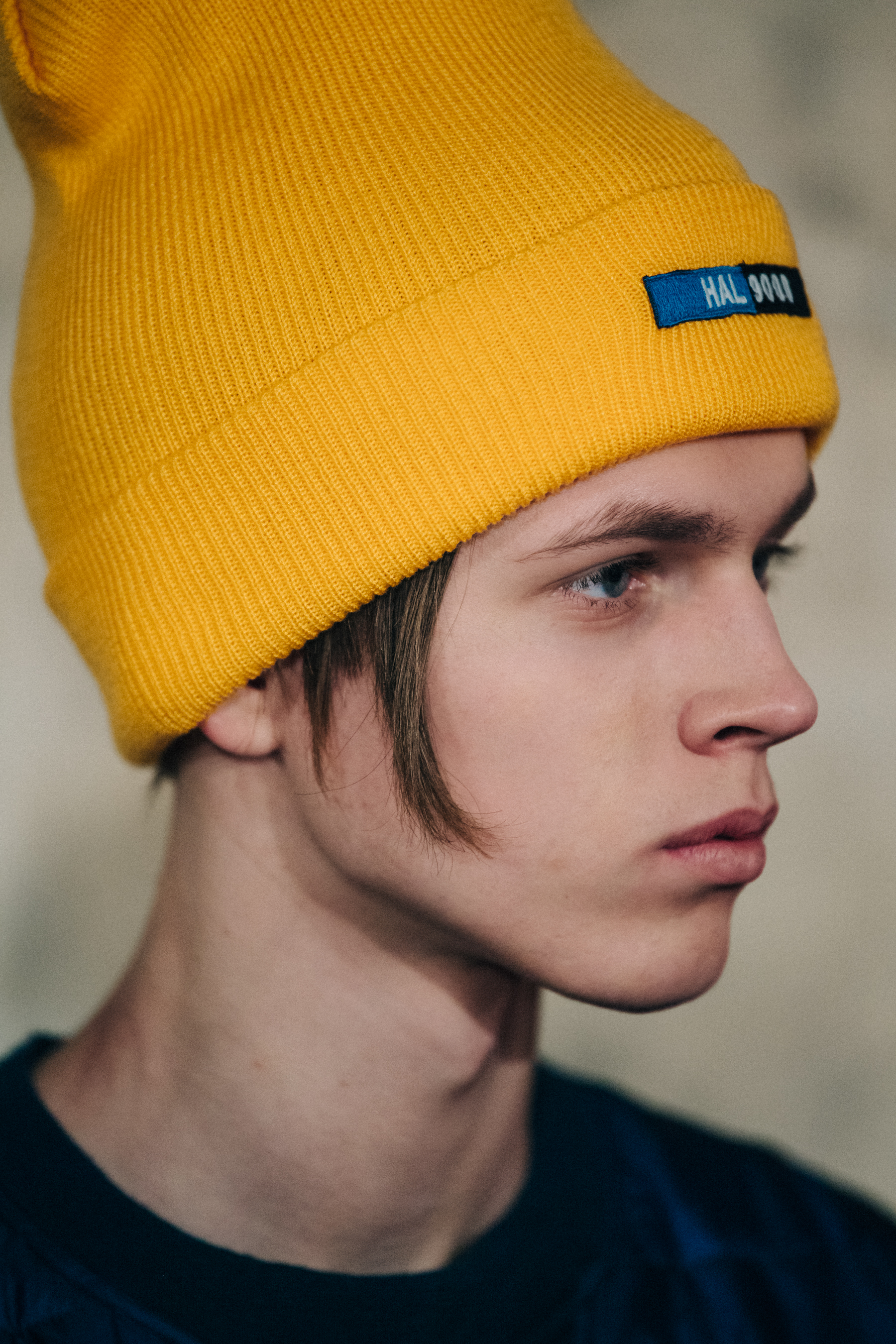 Model wearing yellow beanie