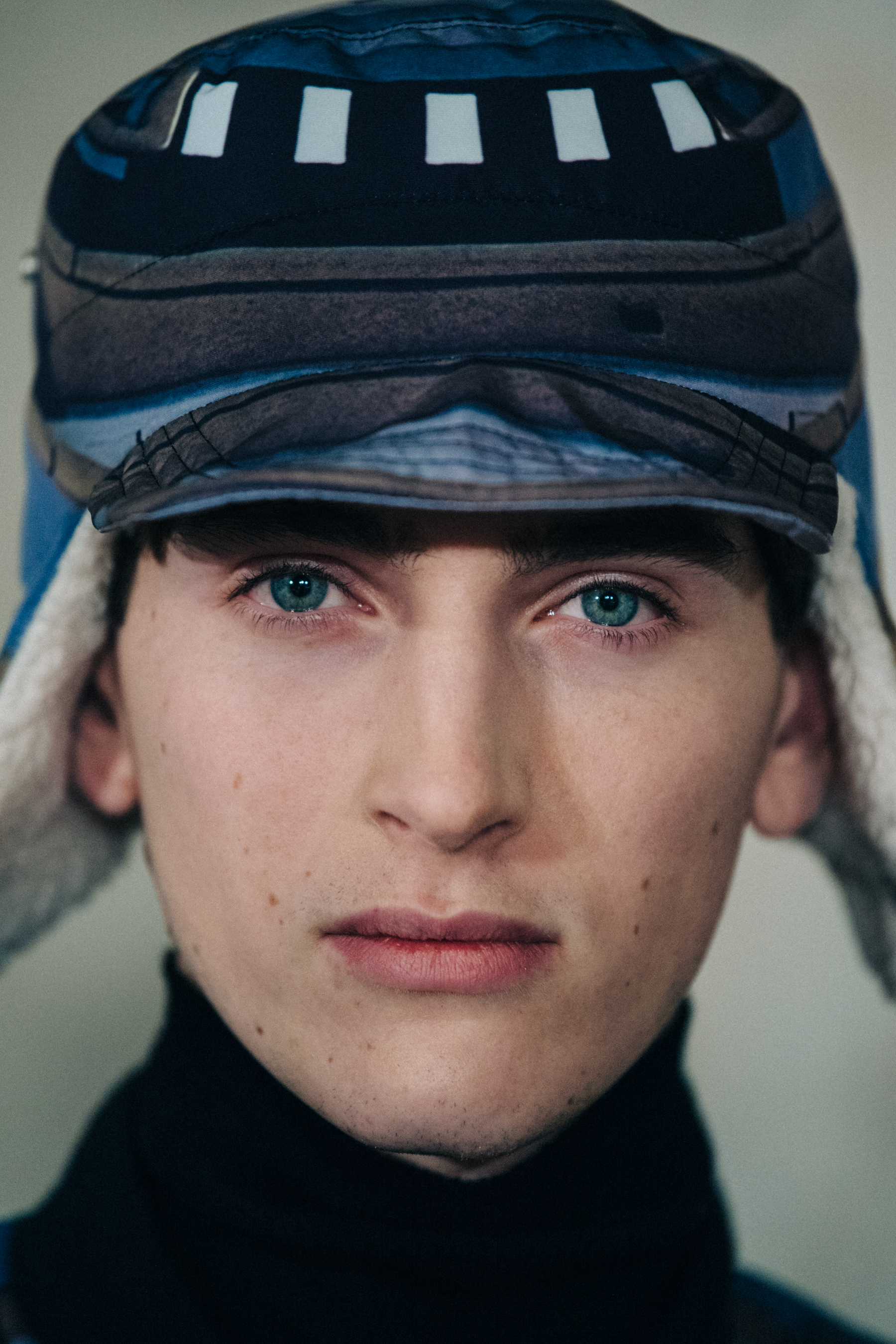 Portrait of model wearing blue pattern hat