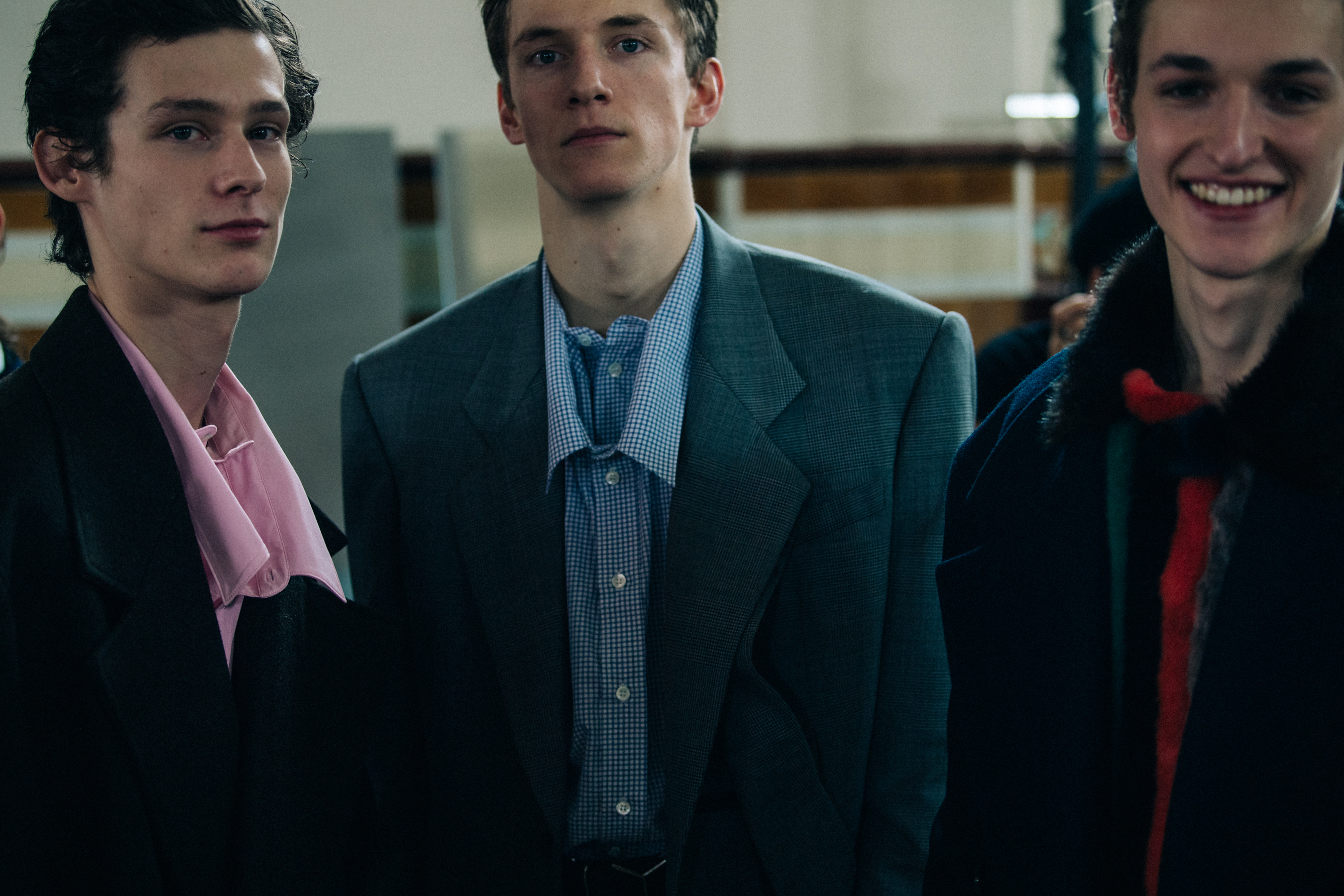 Three models wearing shirts and jackets