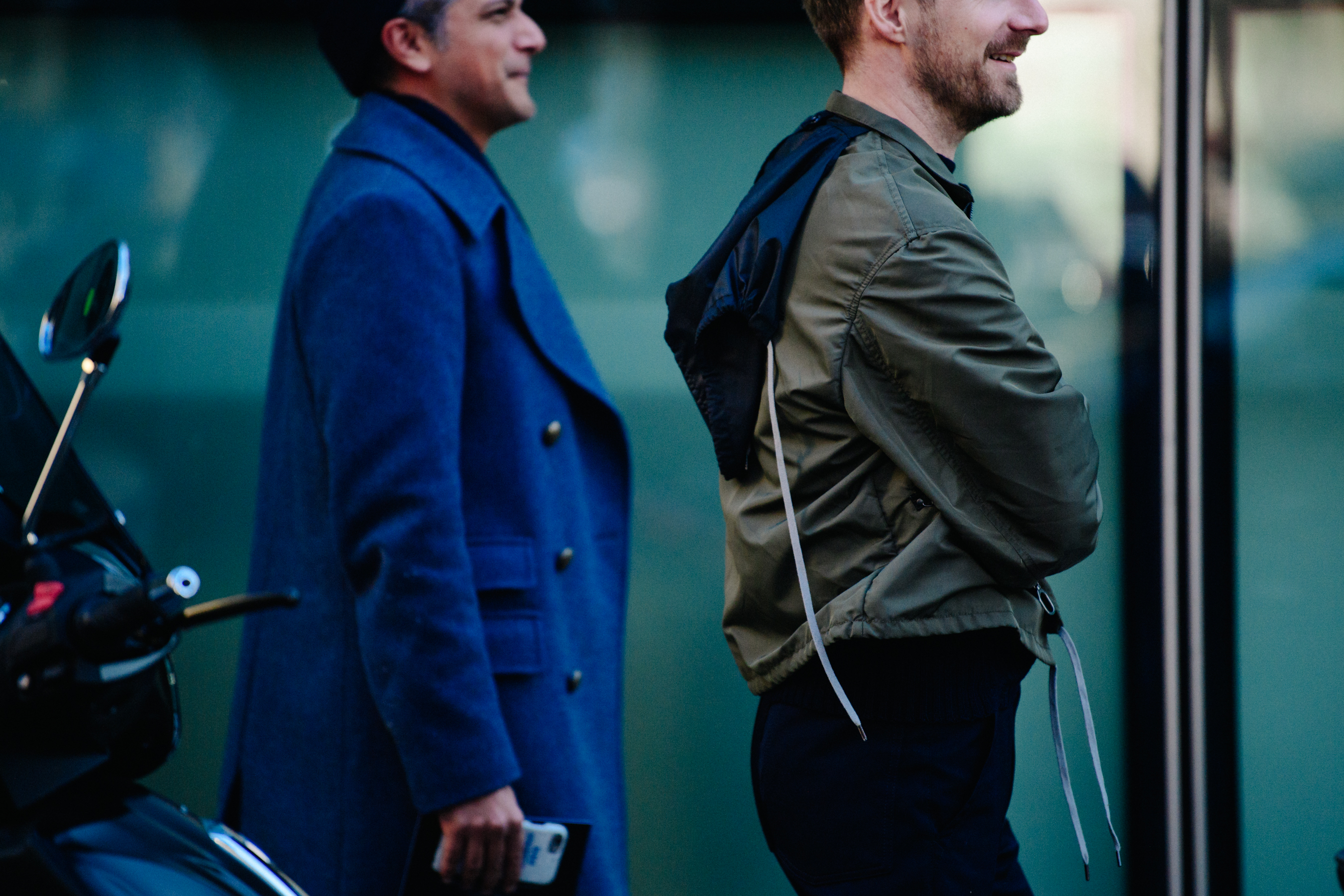 Two men wearing green and blue