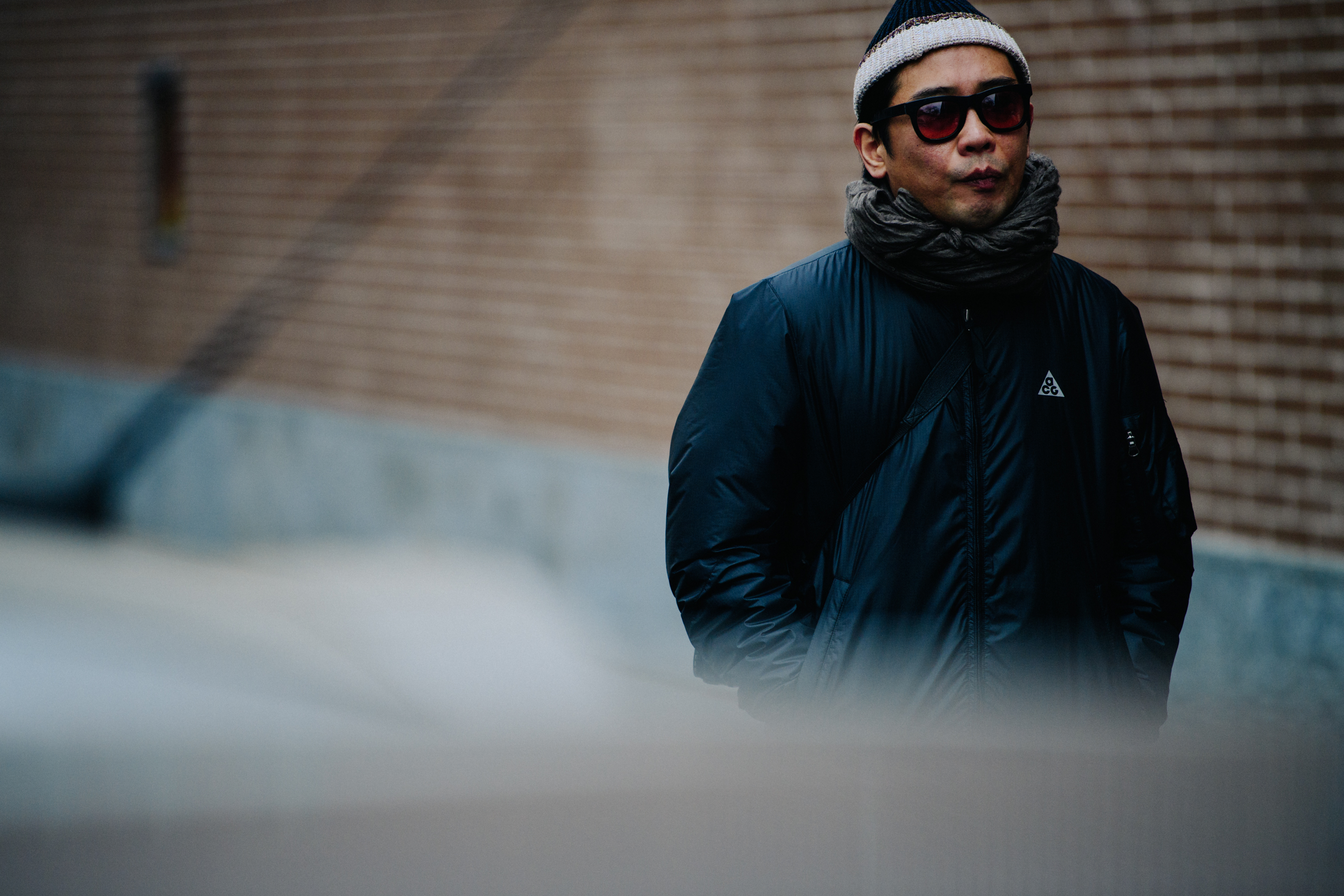 Asian man wearing black Nike ACG jacket