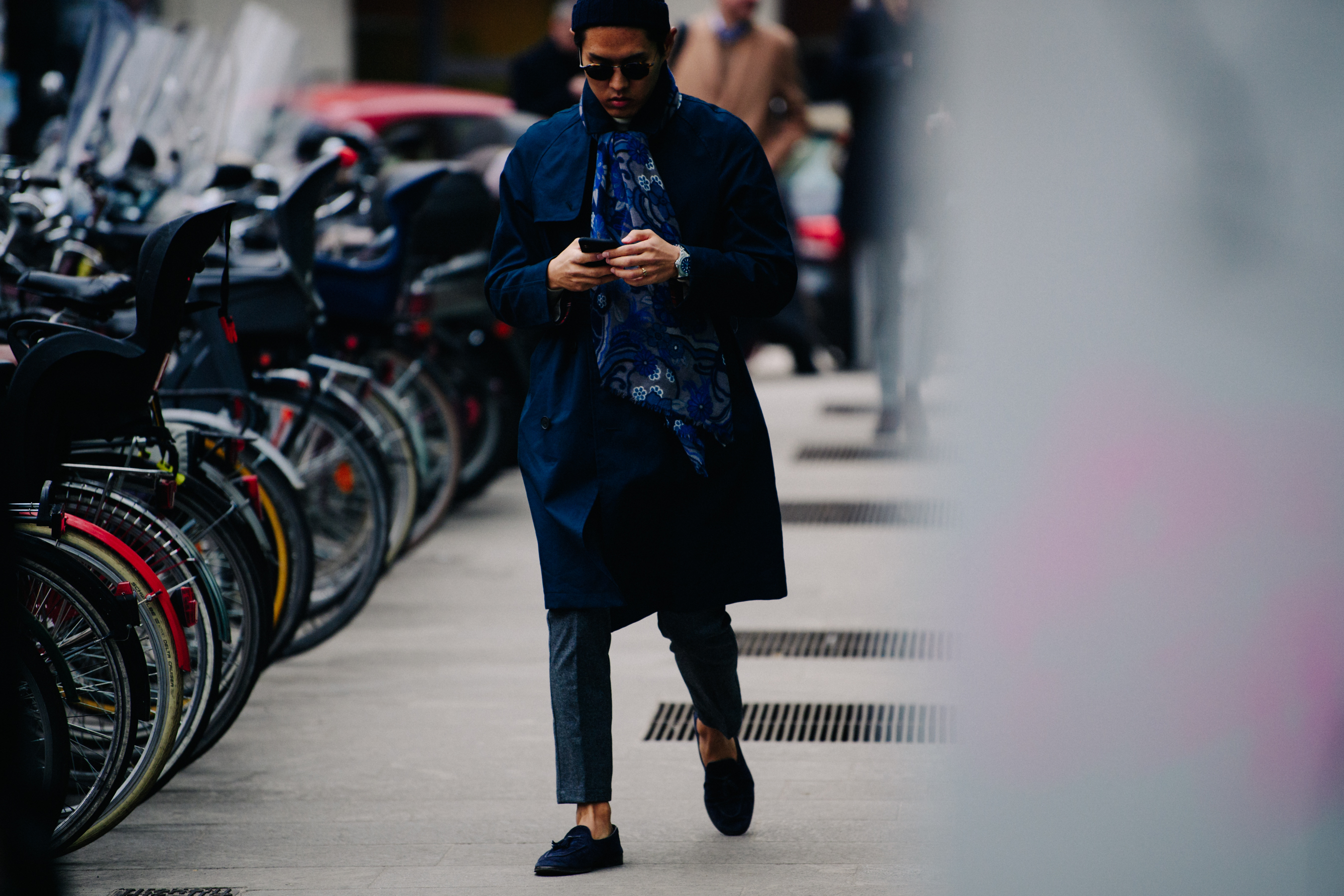 Asian man wearing blue floral scarf
