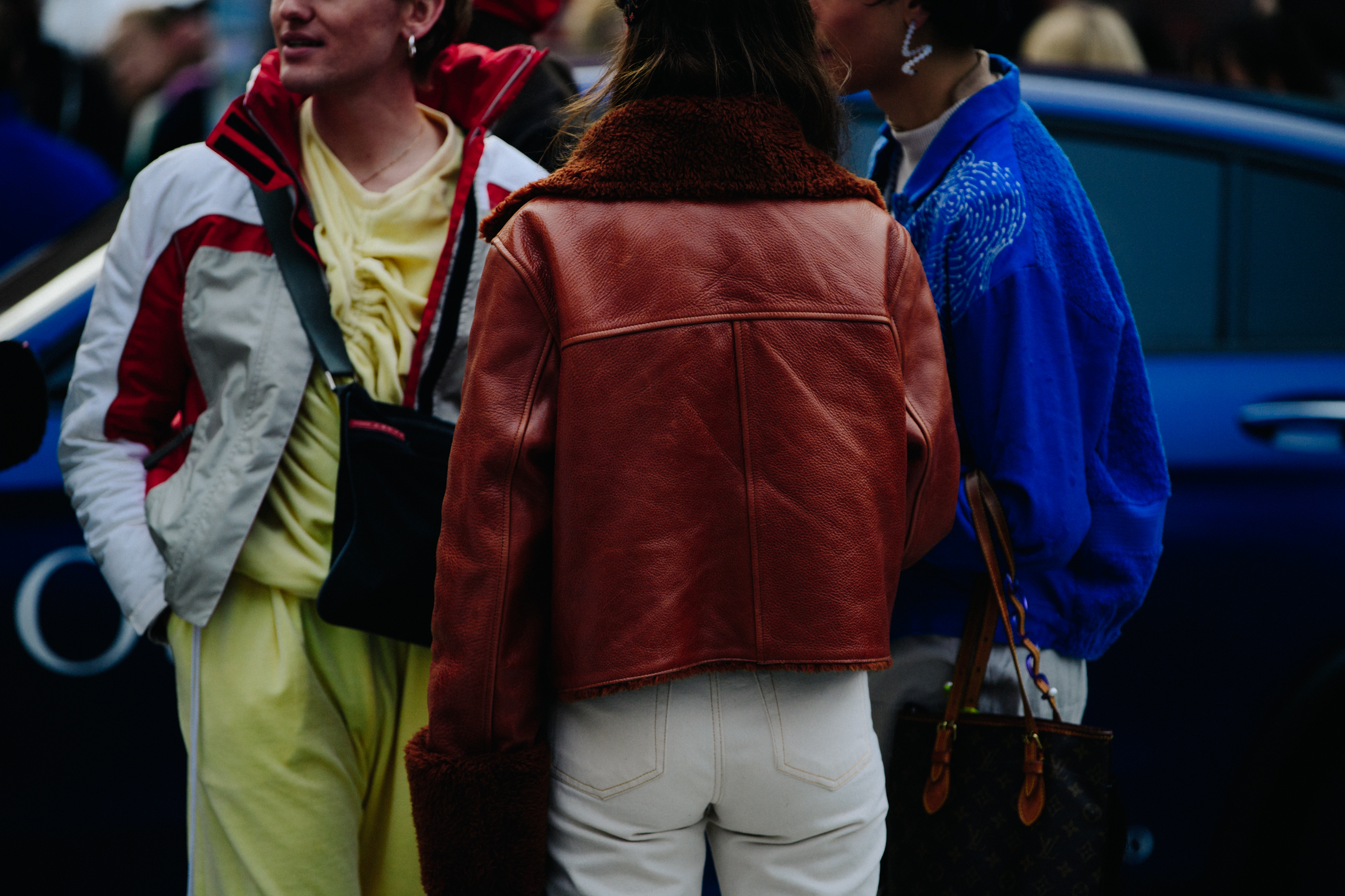Three people wearing colourful jackets