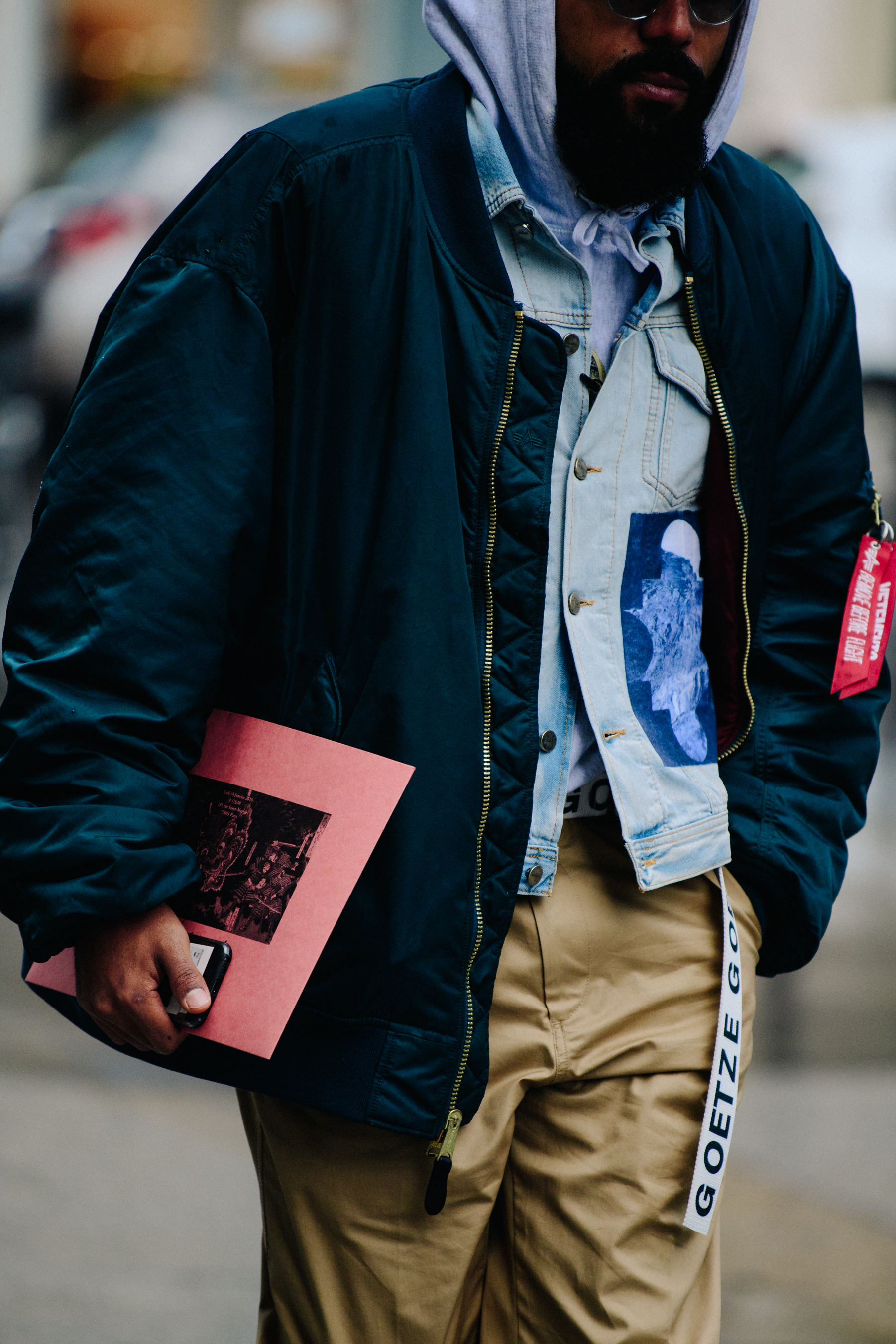 Man wearing navy bomber jacket