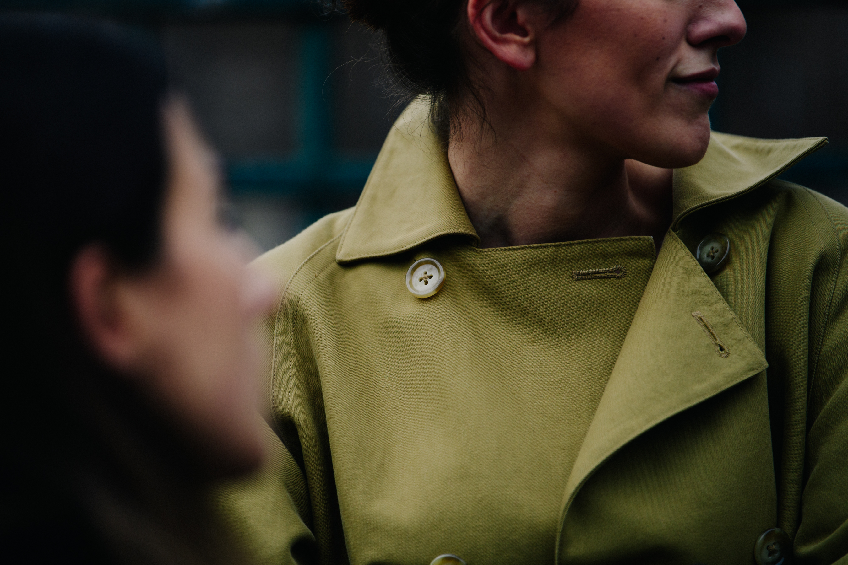 Woman wearing dark yellow coat