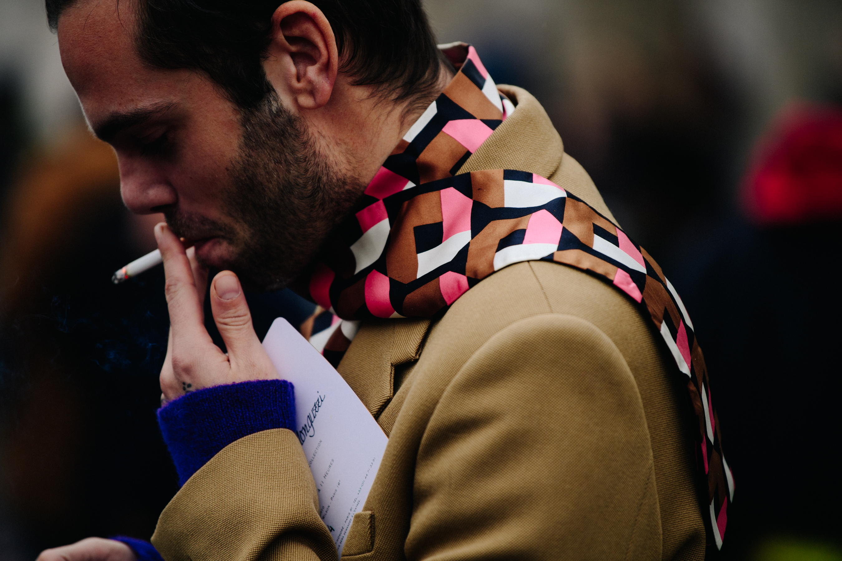 Man wearing pink scarf