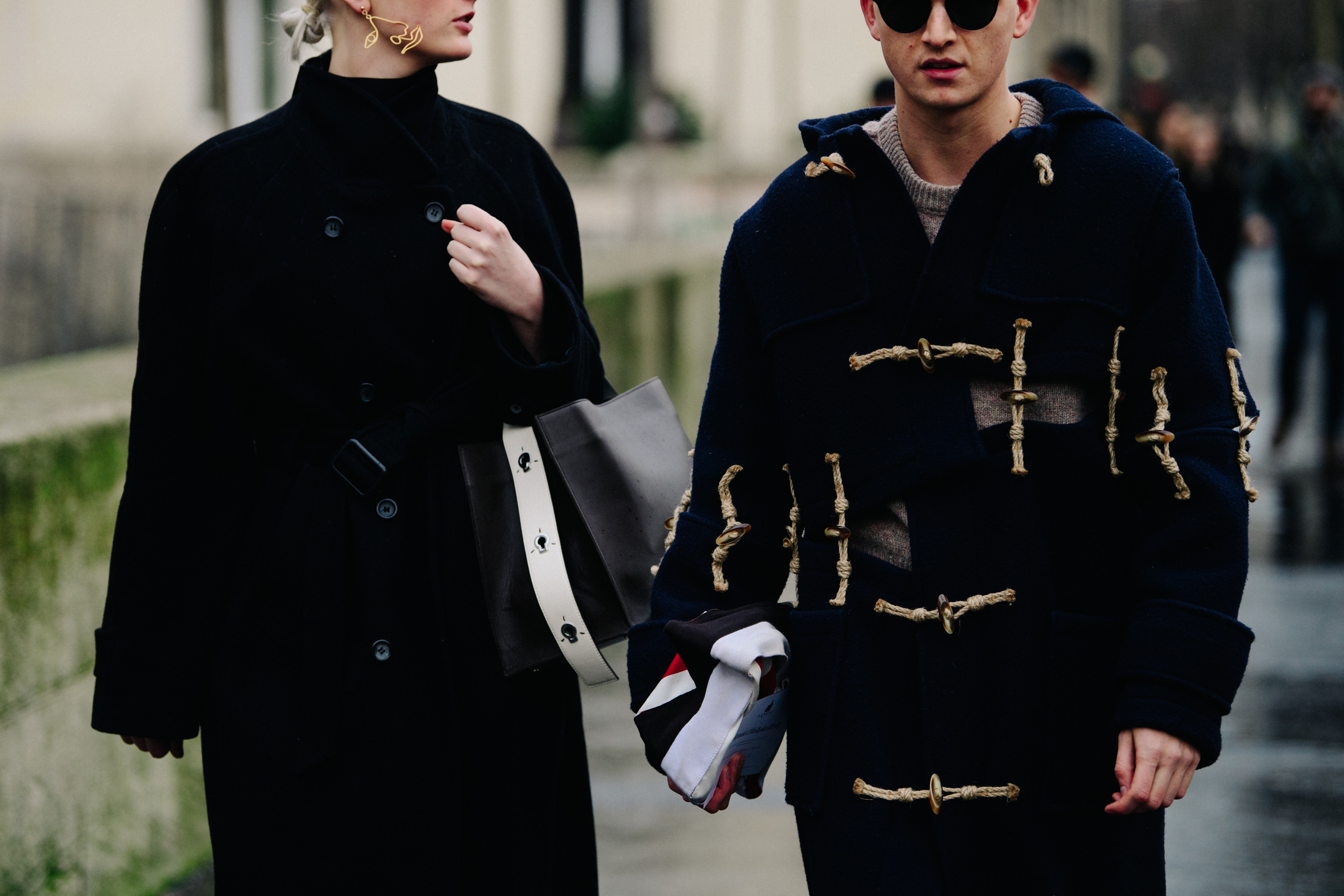 Couple wearing long dark coats