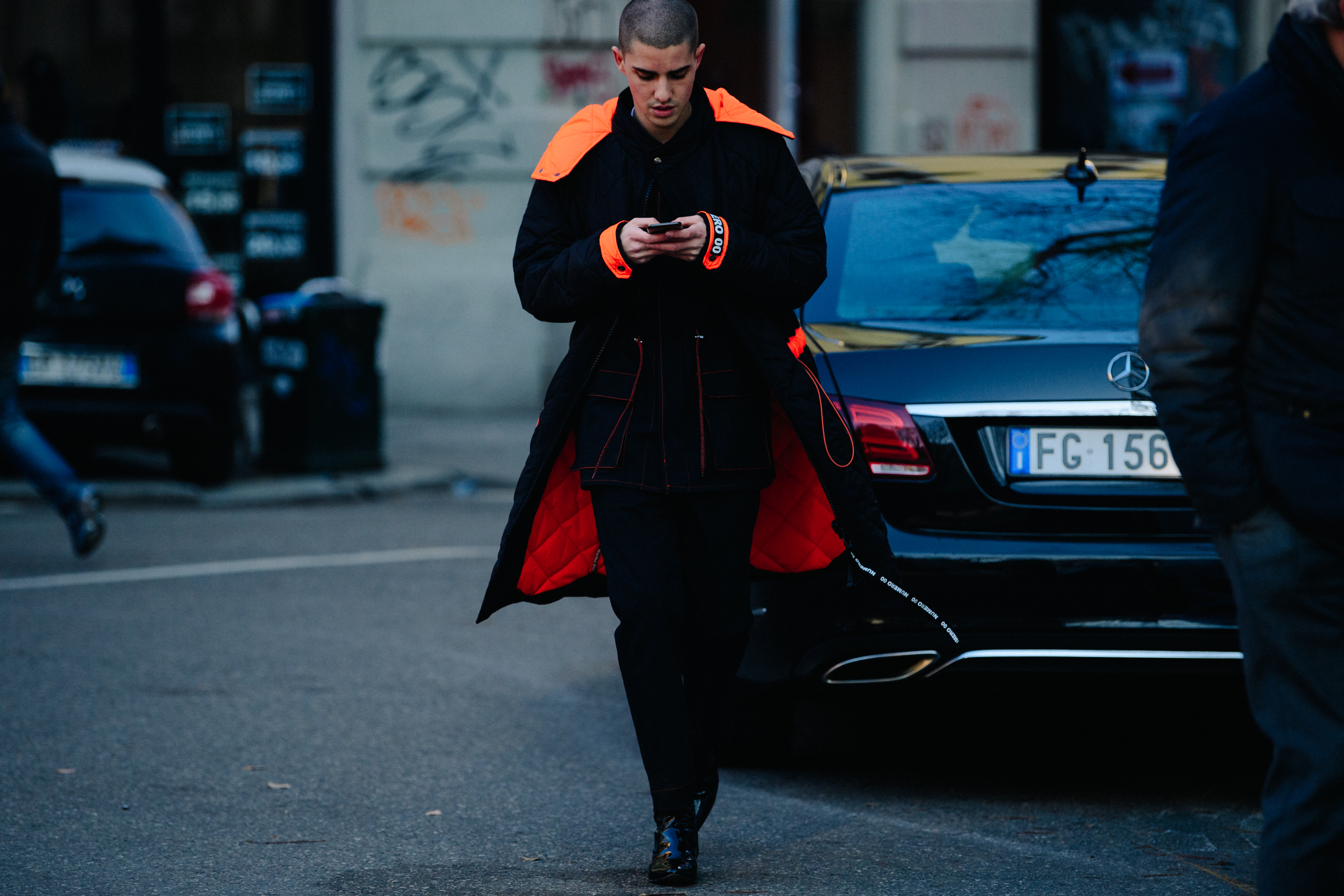 Man wearing long black and orange outfit