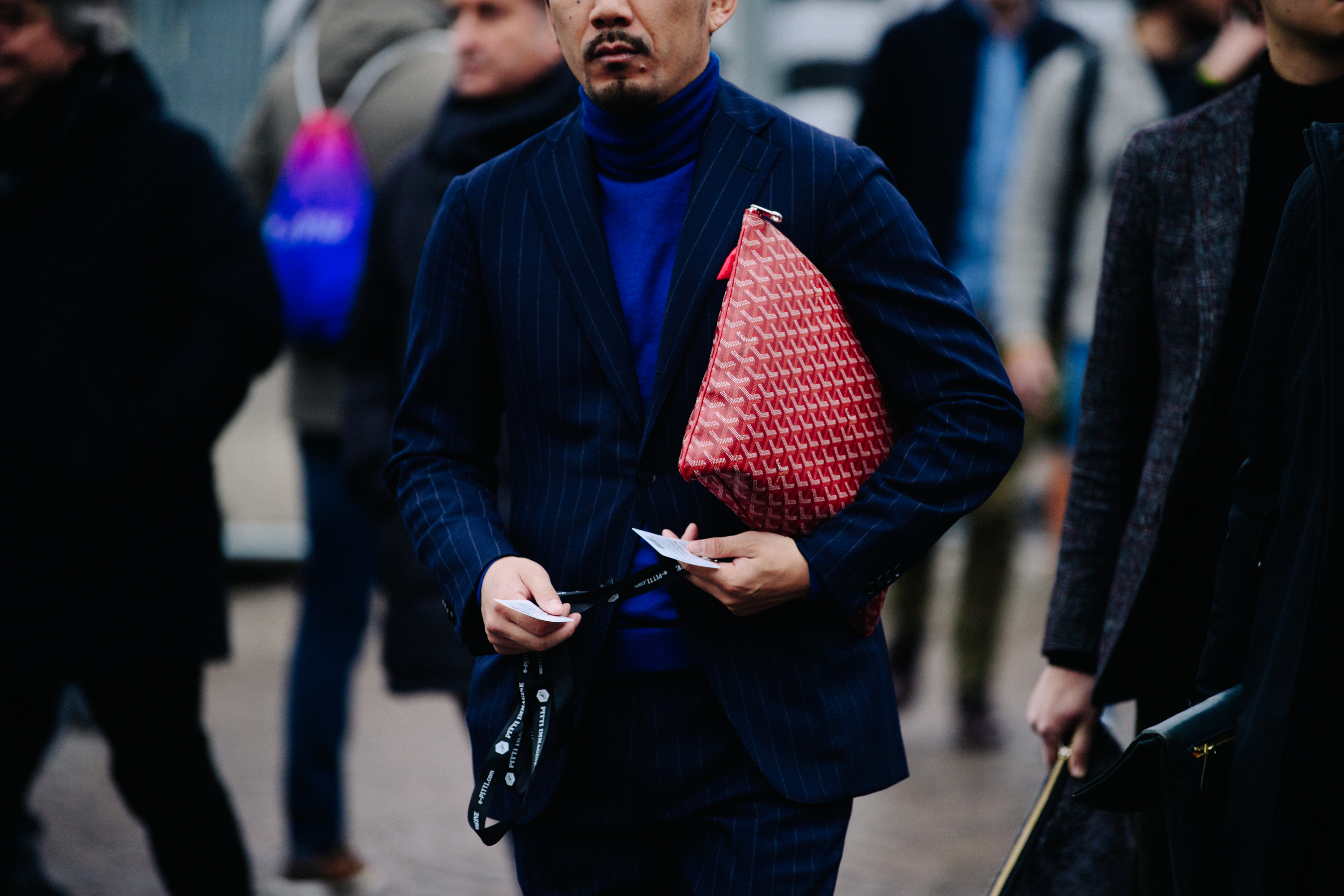 Man holding red pattern bag