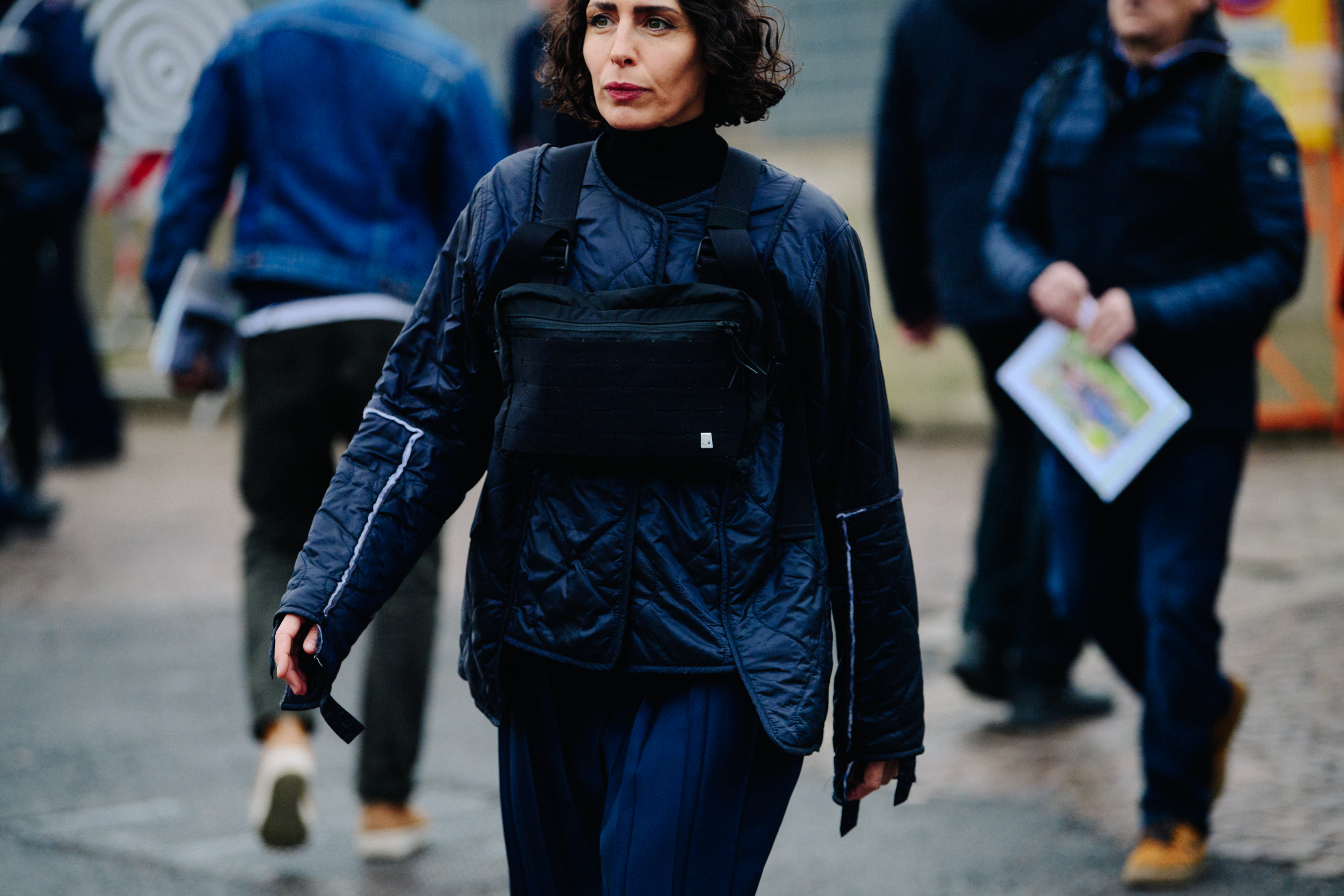 Woman wearing black military bag