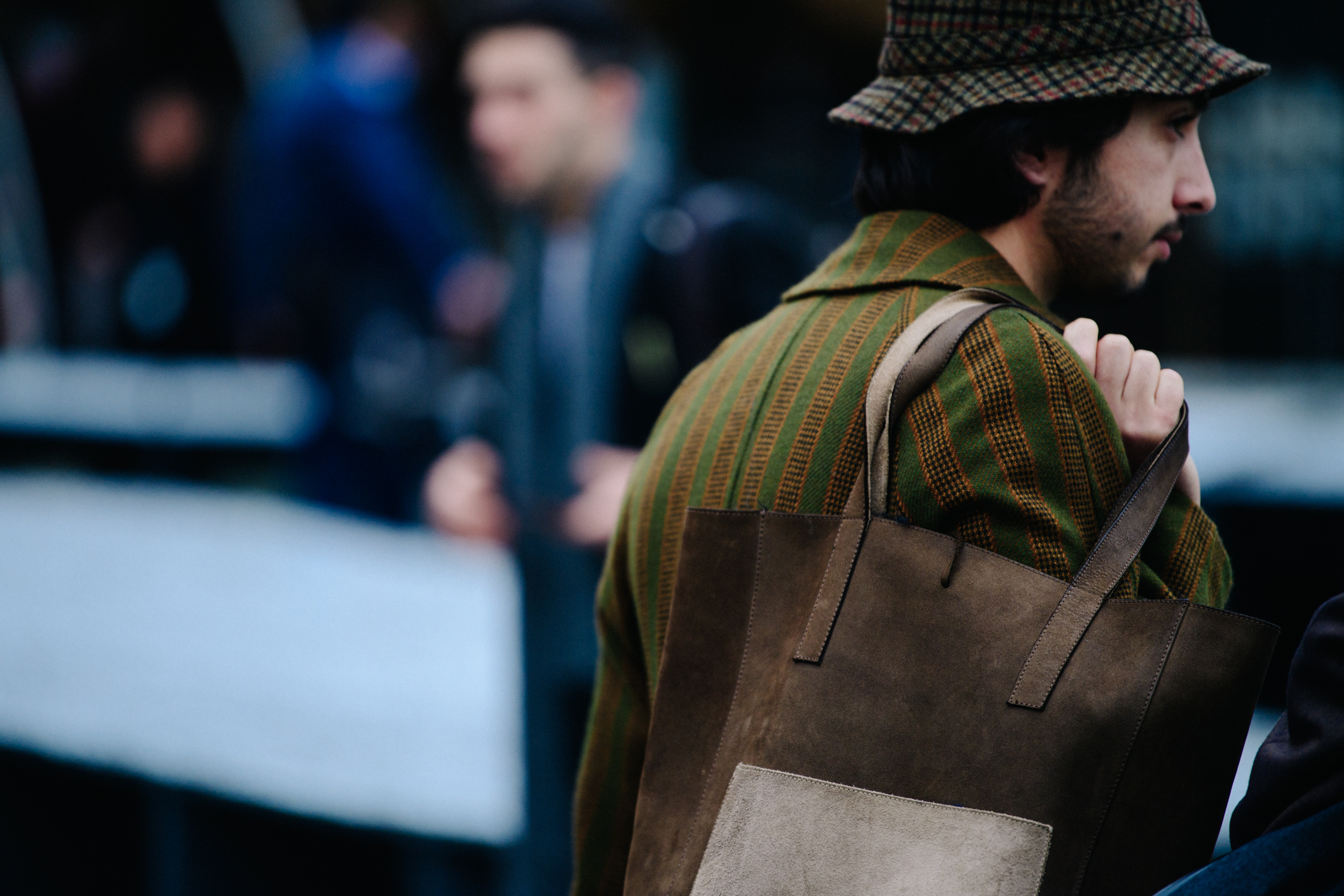 Man carrying brown leather bag