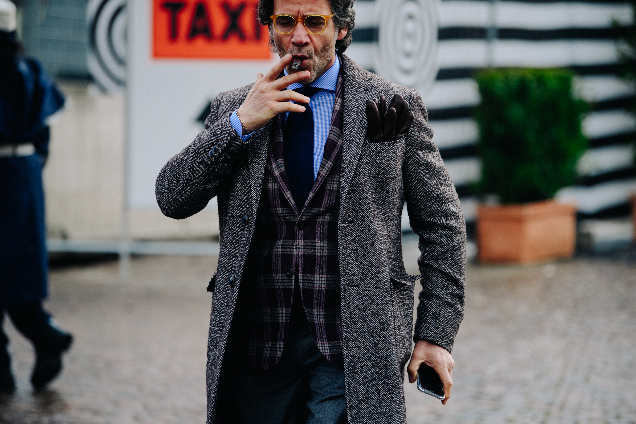 Man smoking cigar in formal clothes