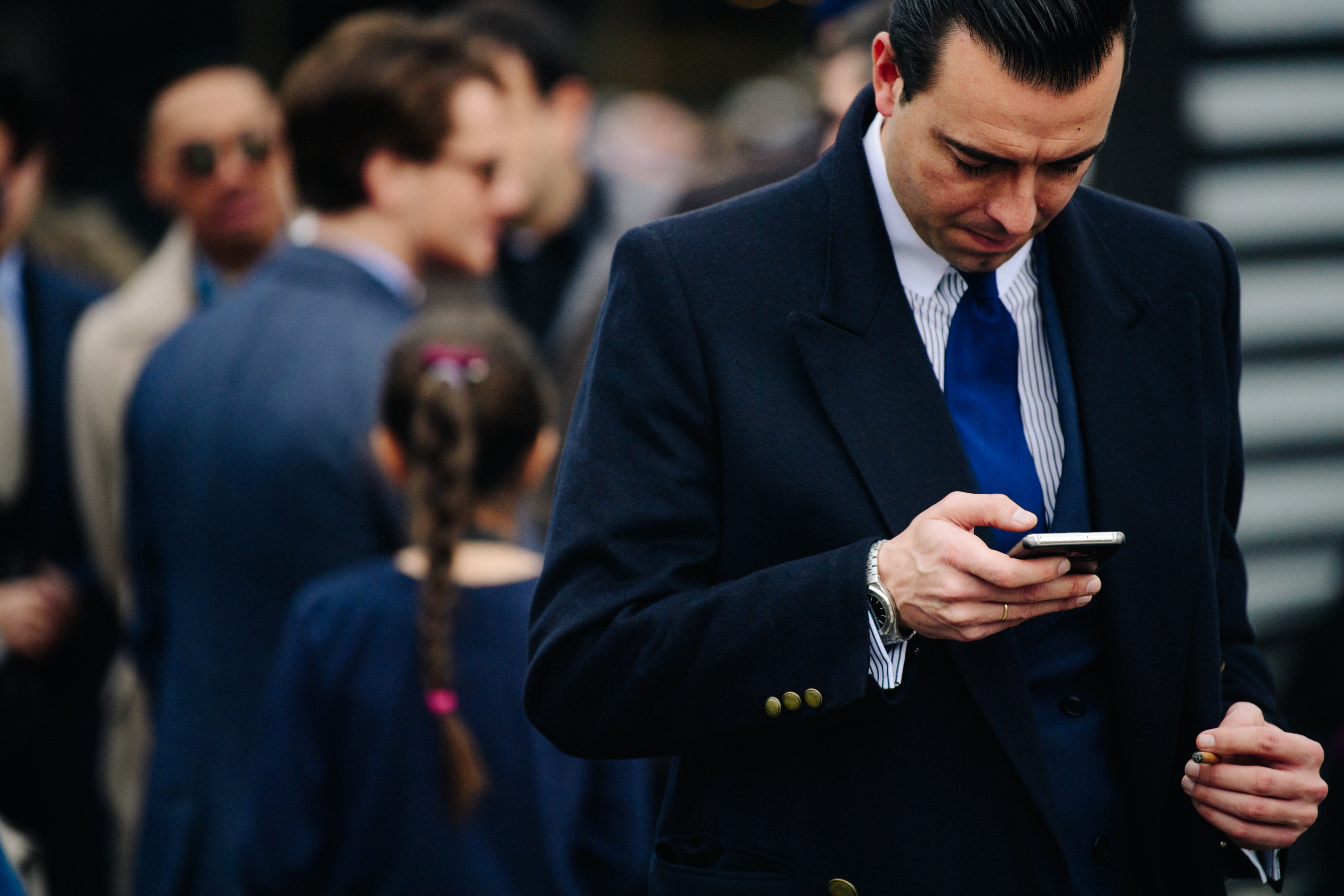Man wearing navy suit and coat