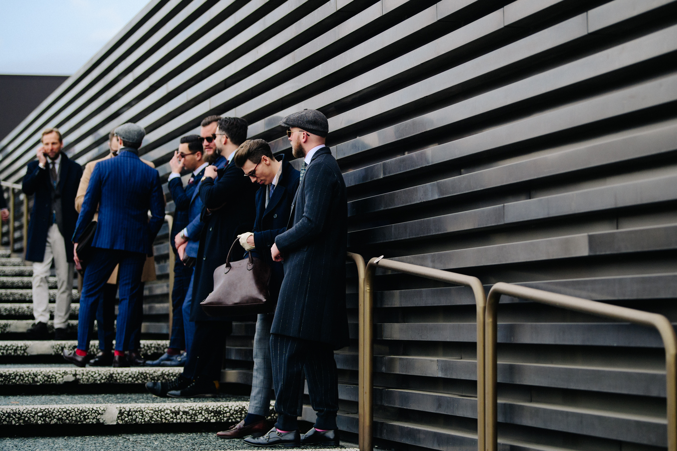 Men waiting in line wearing suits