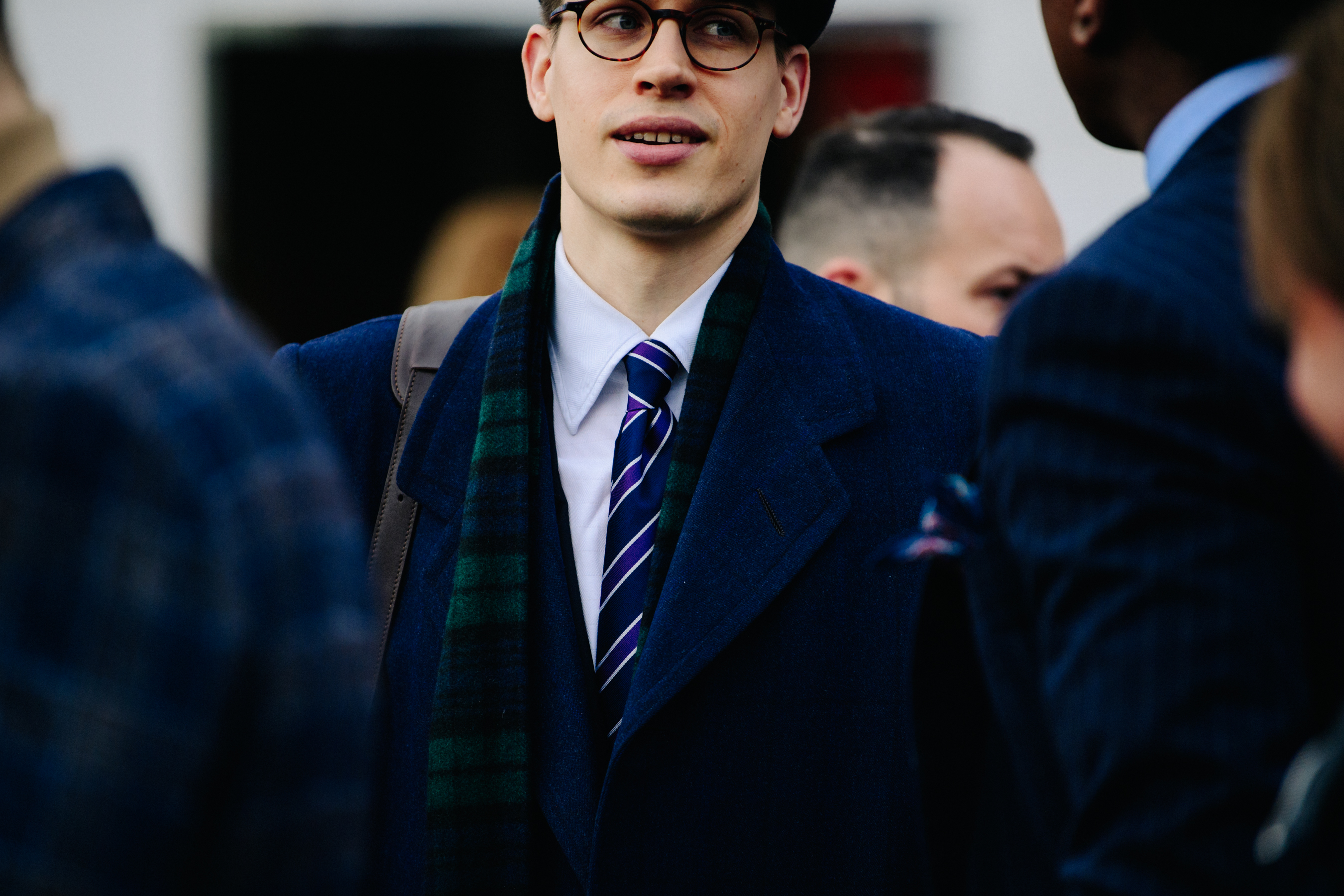 Man wearing blue coat over shirt