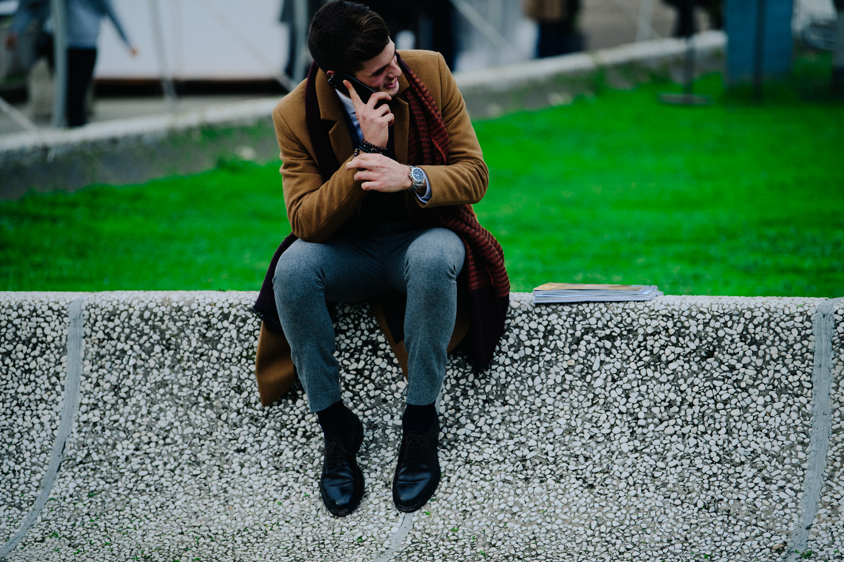 Man sat on wall on phone