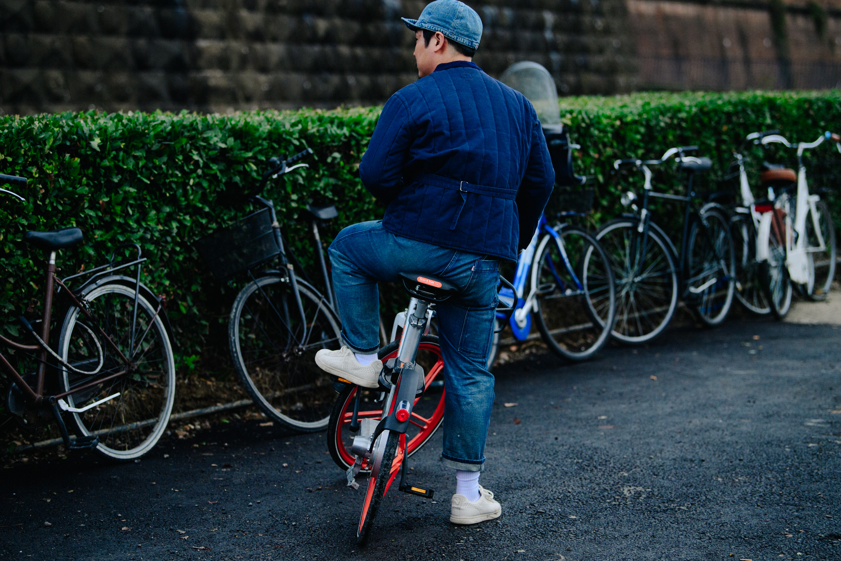 Man wearing all blue outfit on bike