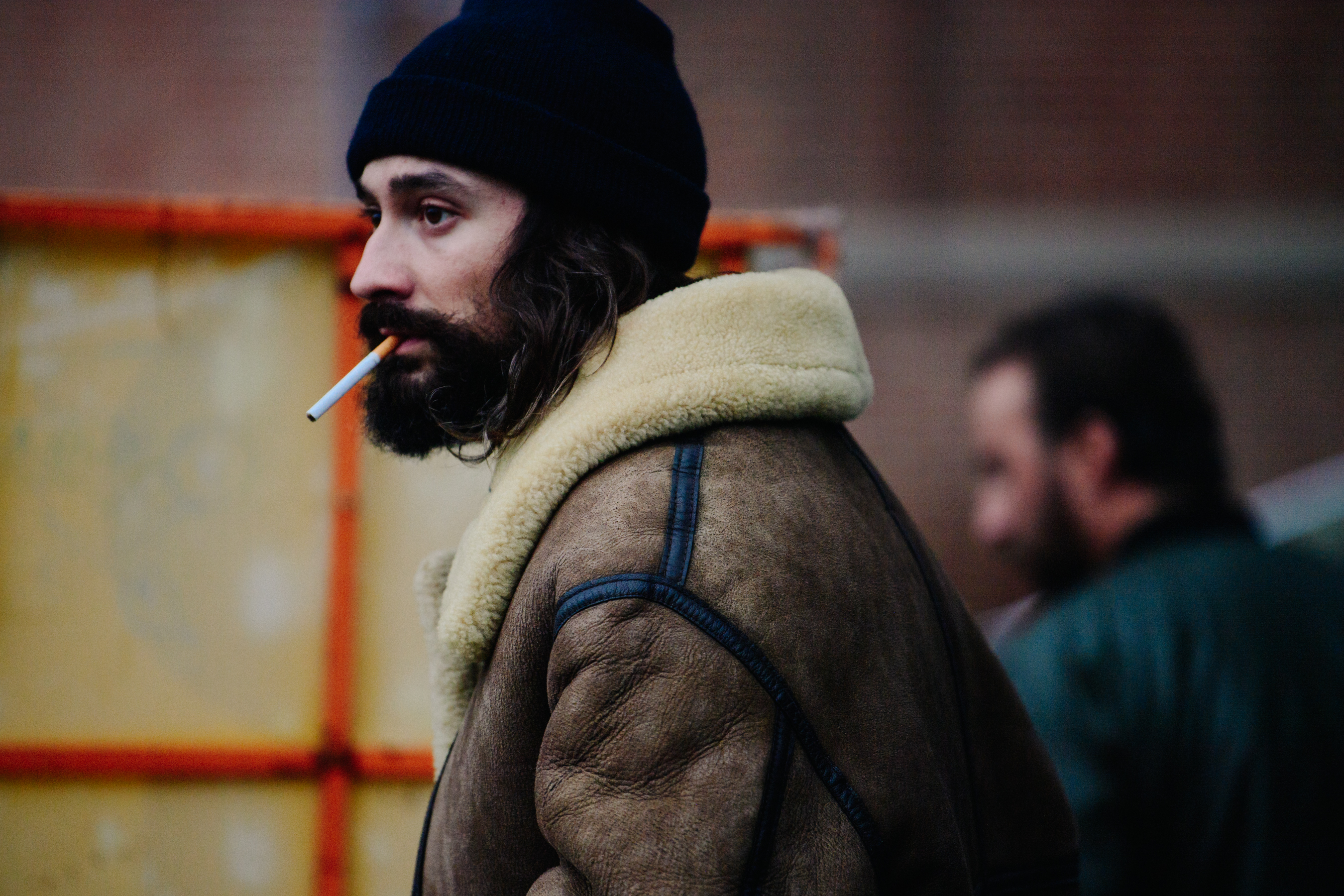 Man smoking in shearling jacket