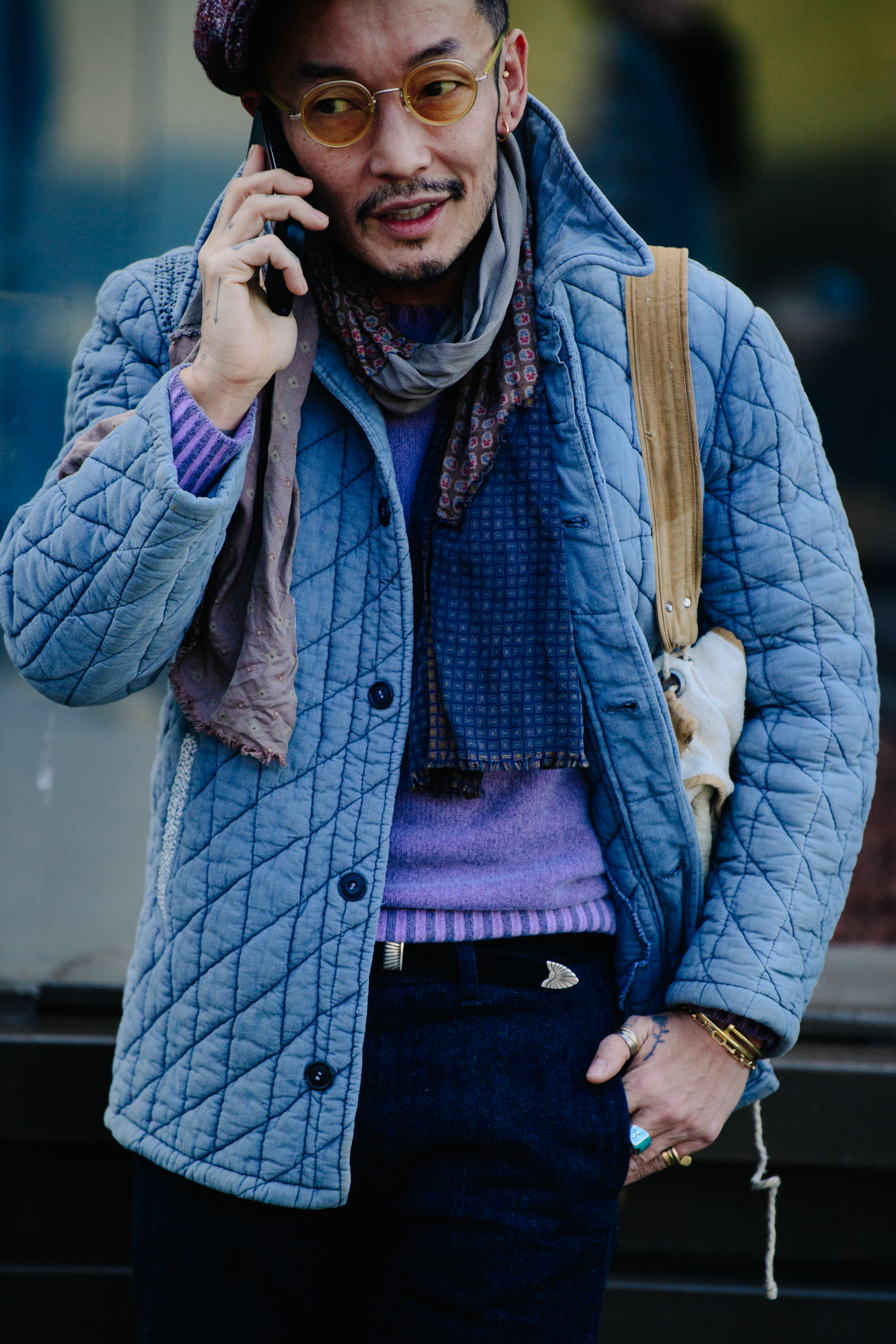 Asian man wearing blue and purple outfit