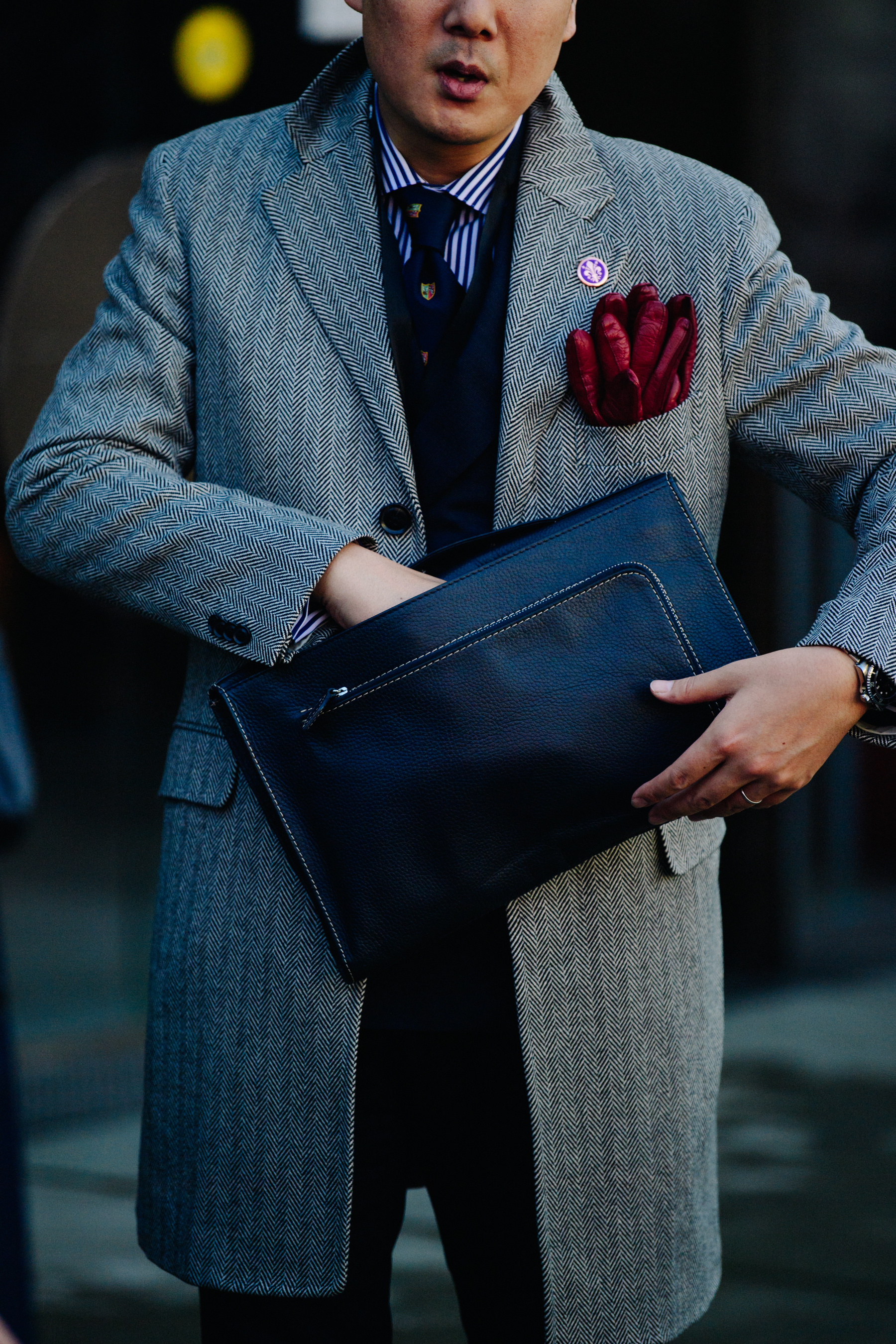 Asian man holding leather case