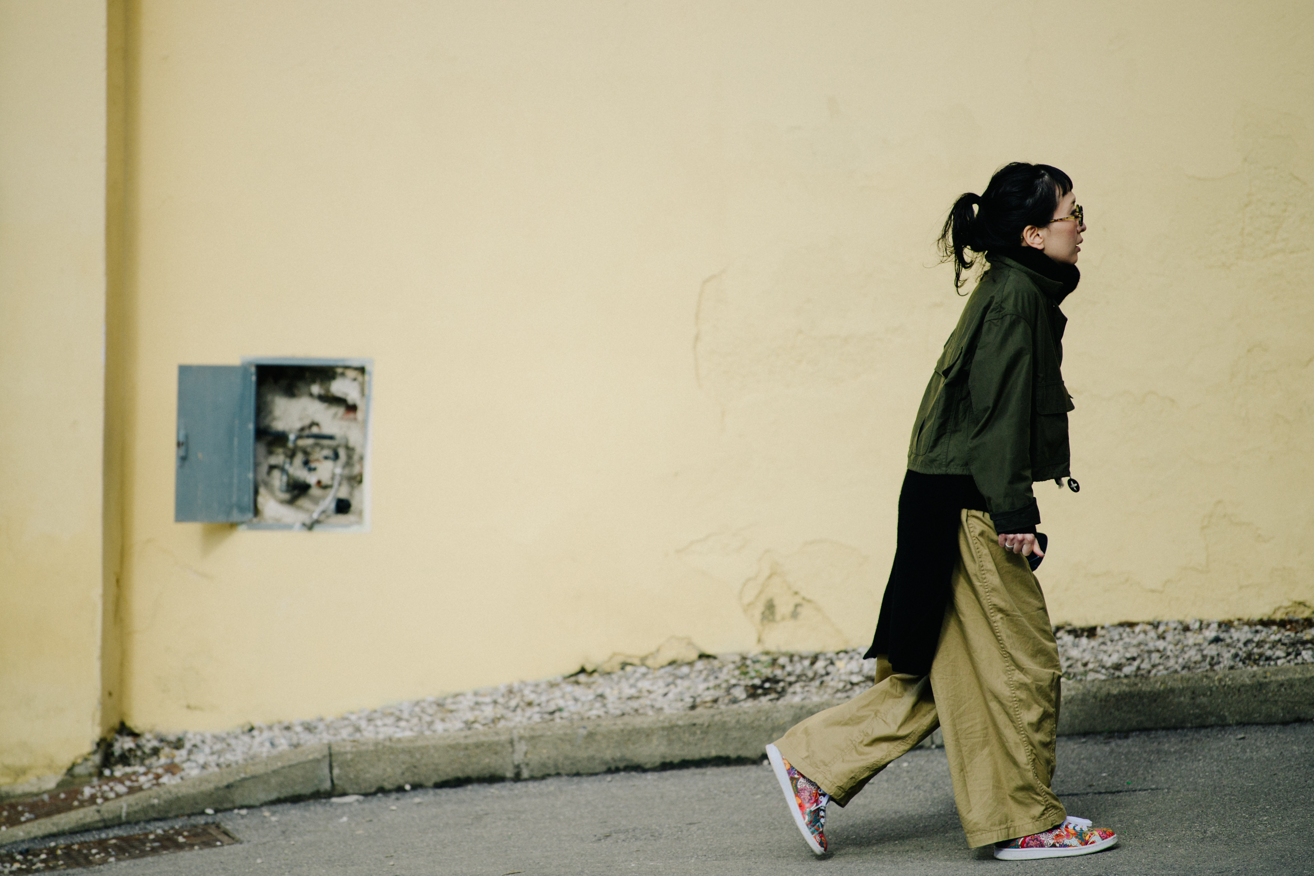 Woman wearing green and tan outfit