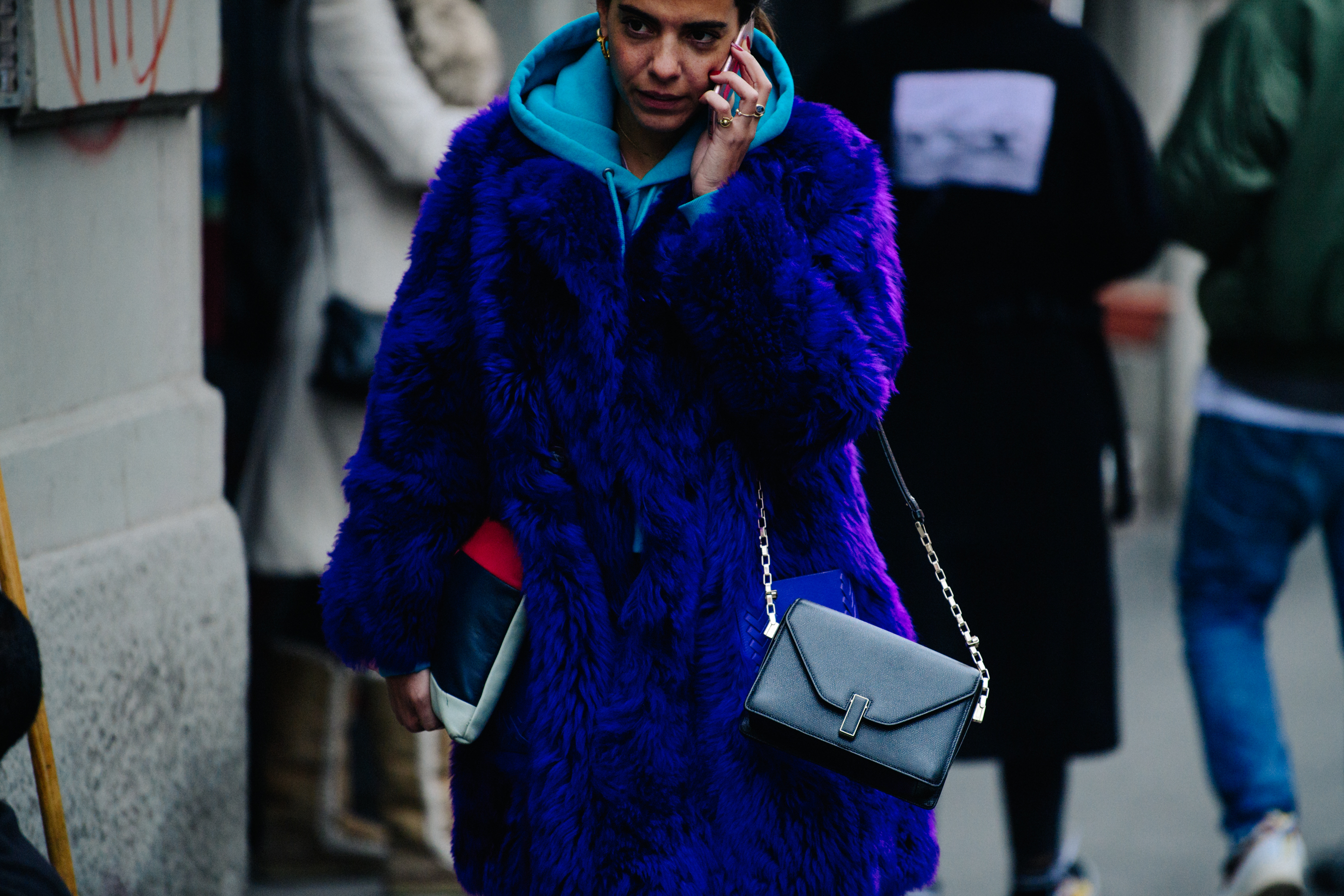 Italian woman wearing bright purple fur coat