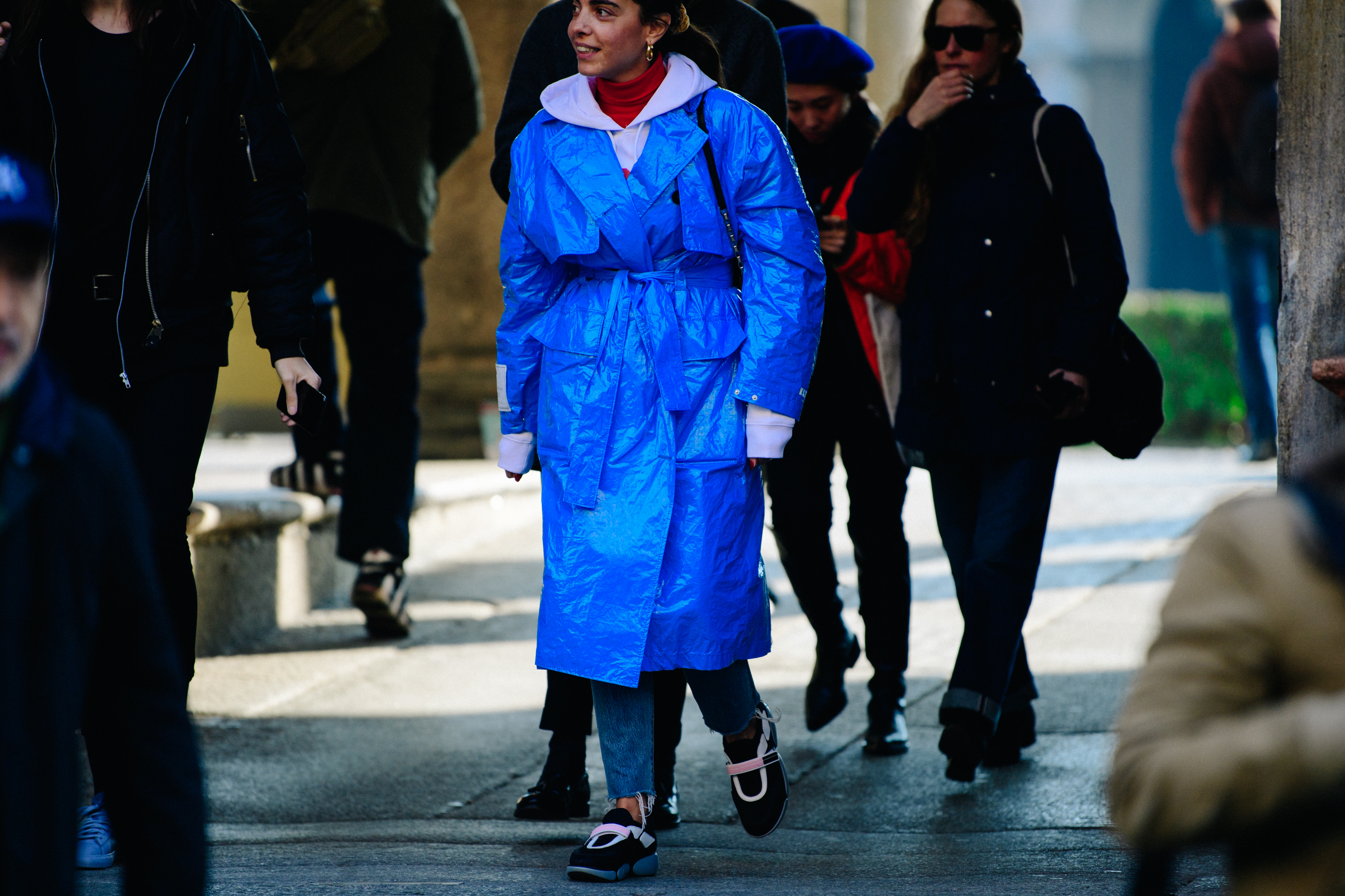 Woman wearing blue plastic coat