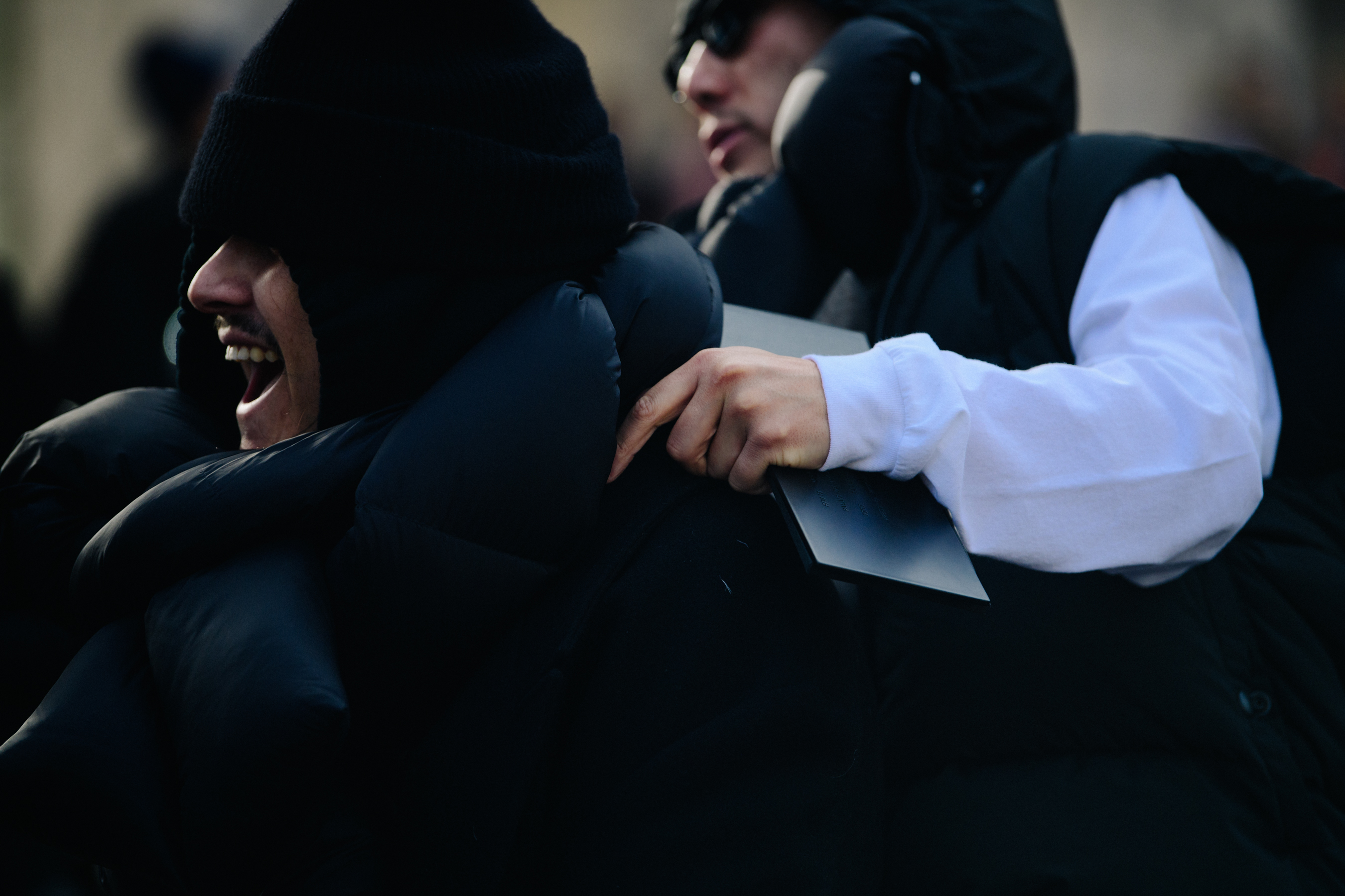 Two men wearing black winter coats