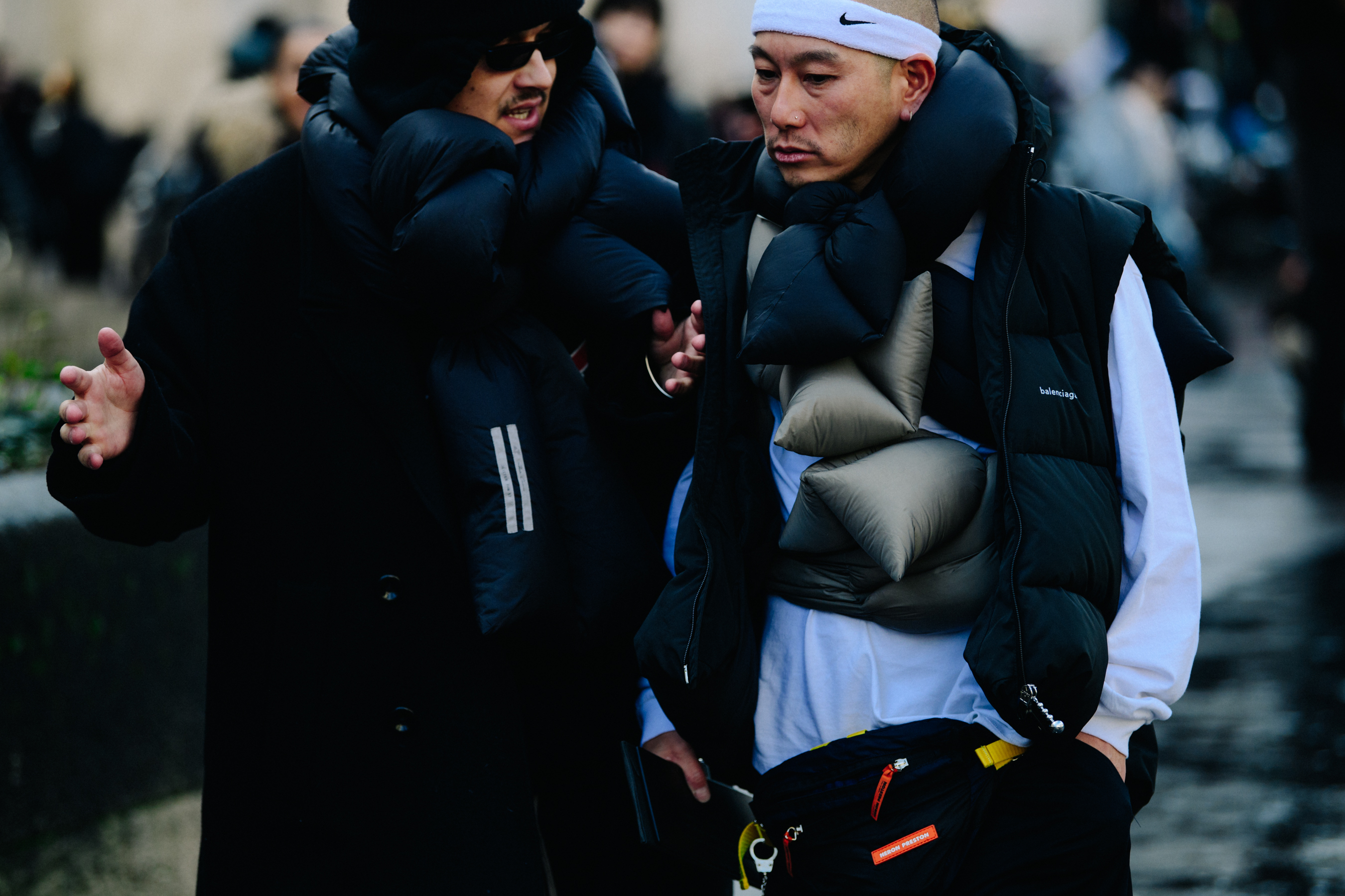 Two men wearing black winter coats