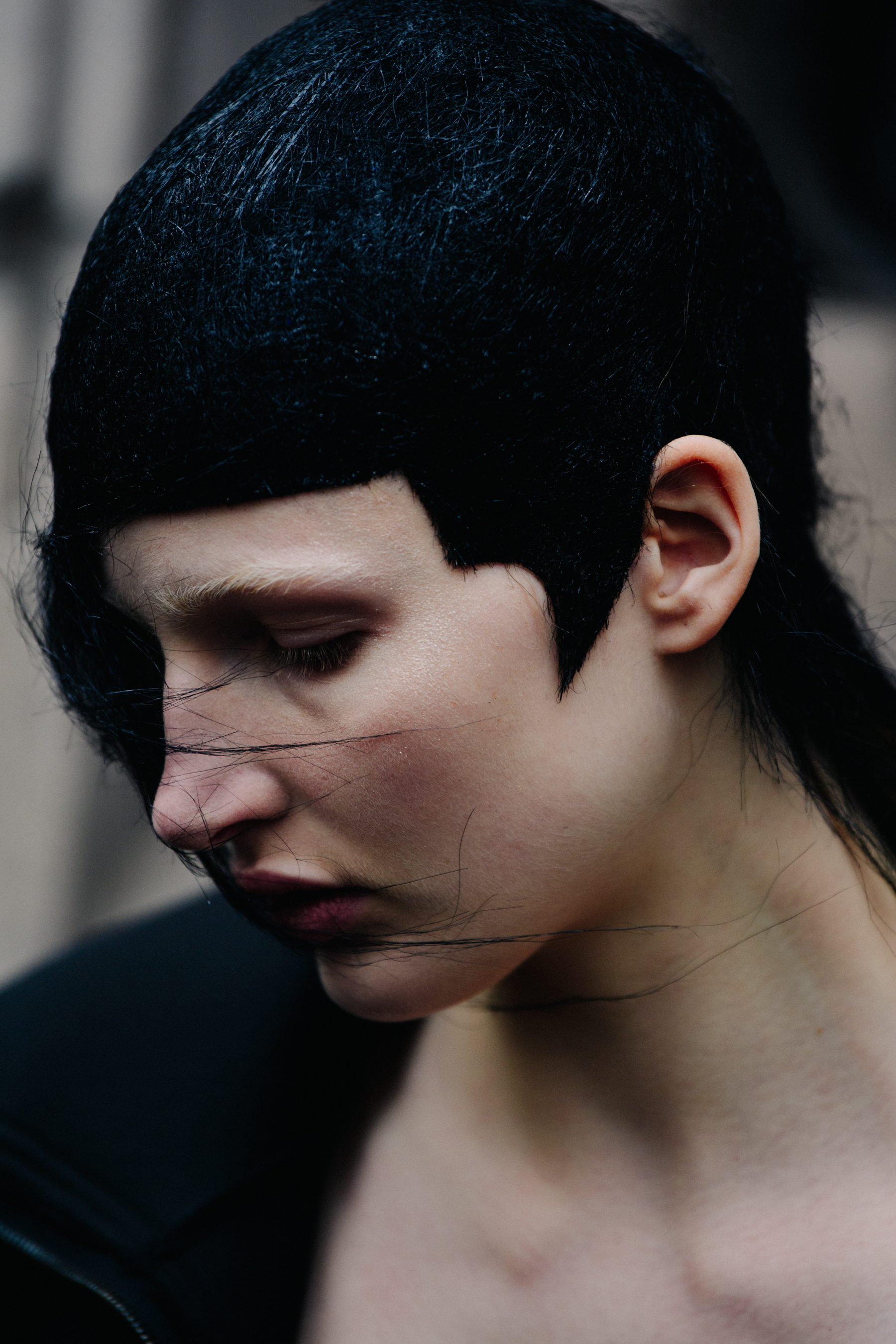 Portrait of Leah Rodl wearing black wig