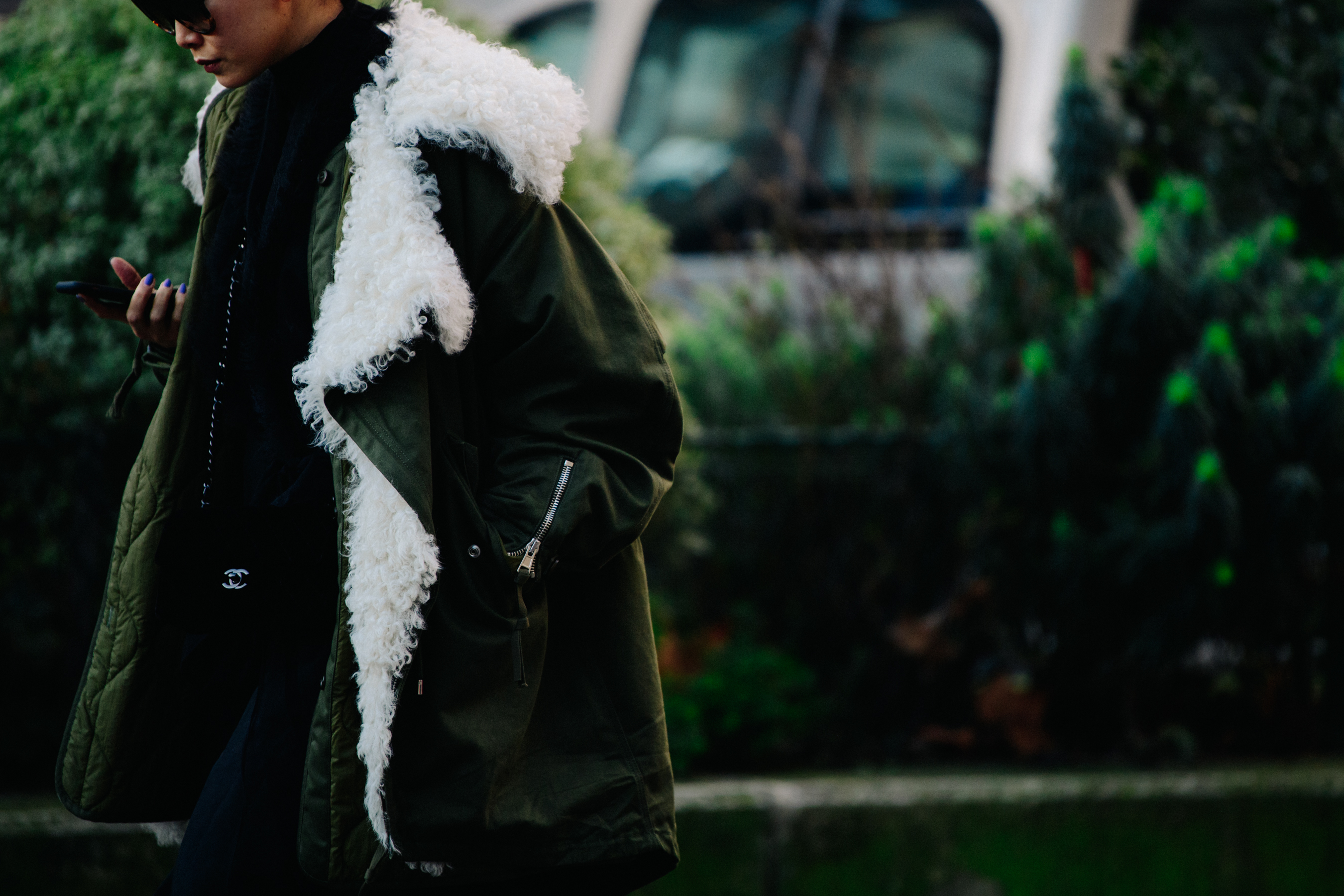 Asian woman wearing Chanel bag