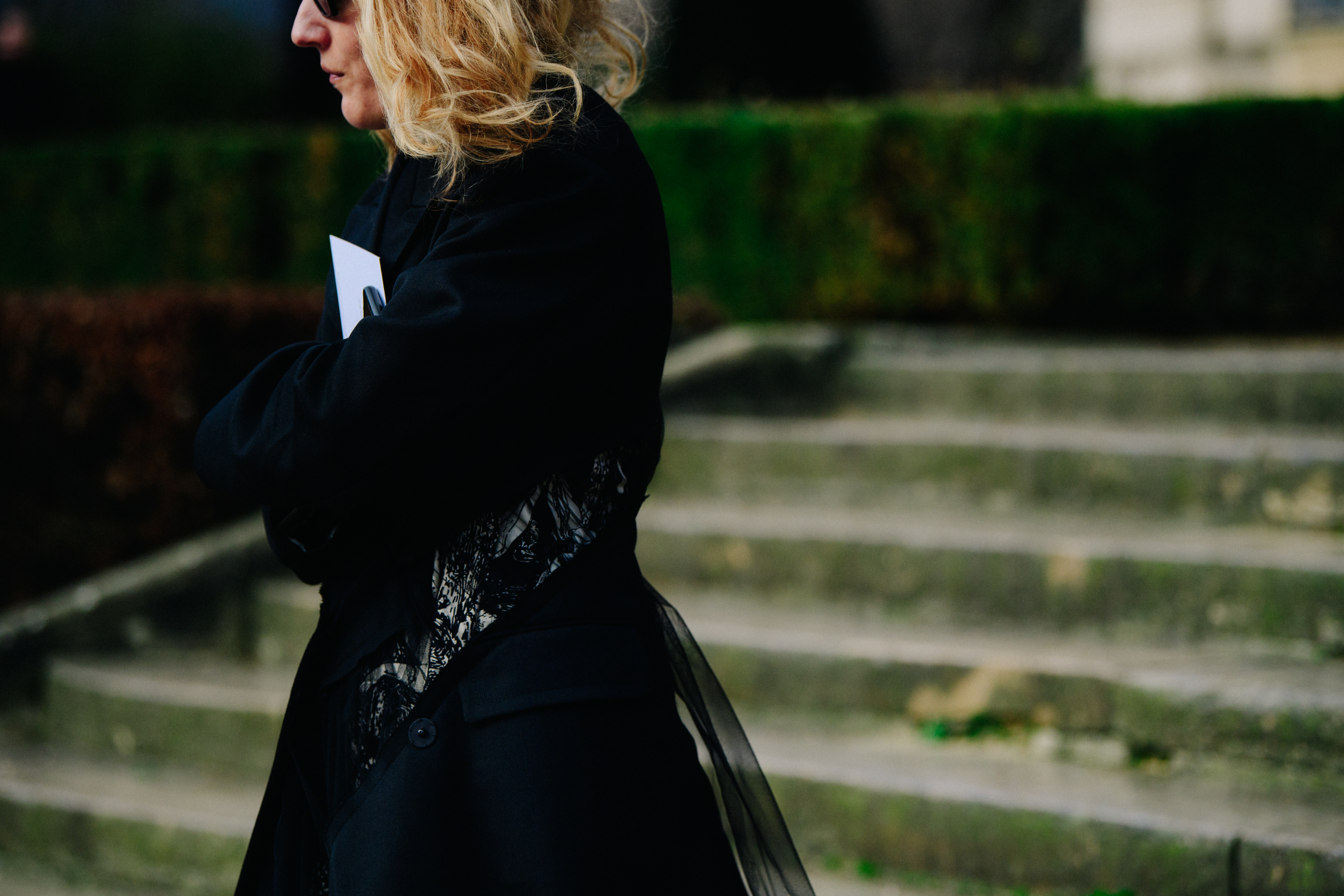 Woman wearing black mesh coat