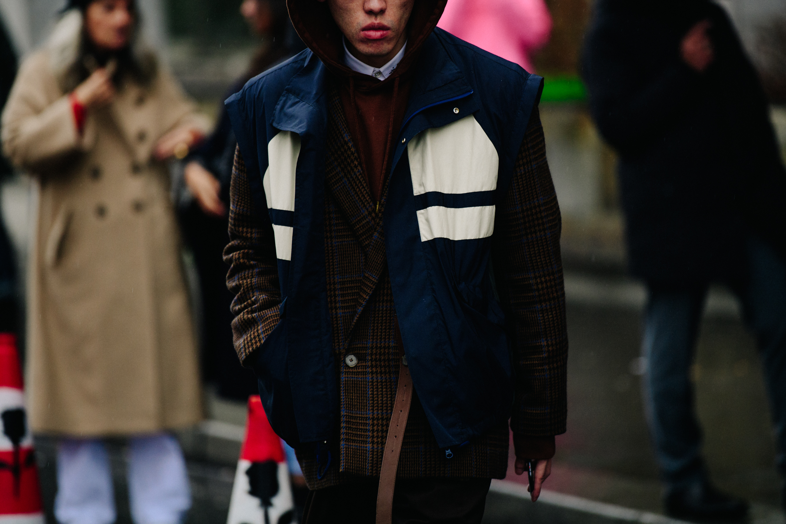 Asian man wearing blue gilet