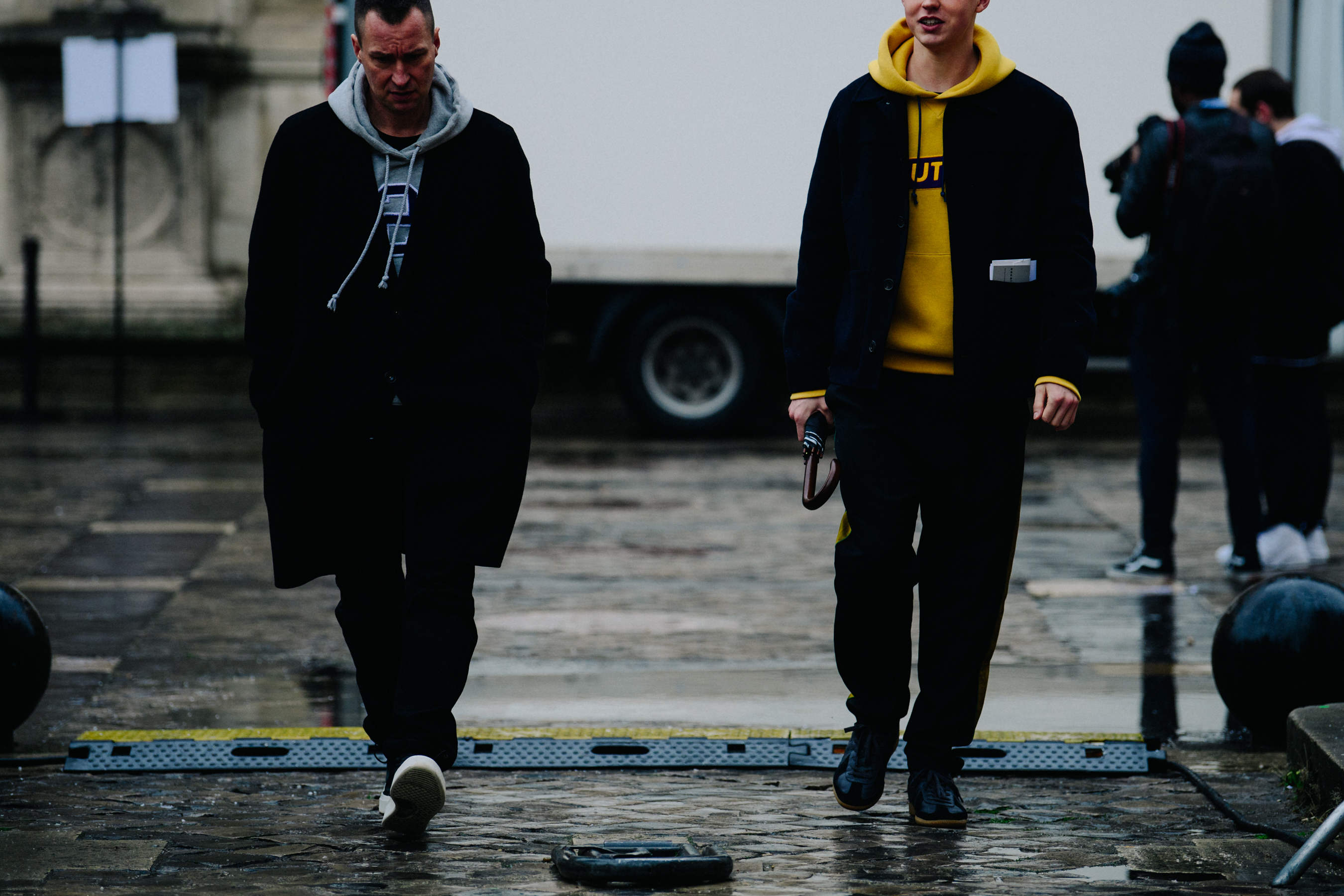 Two men wearing black coats