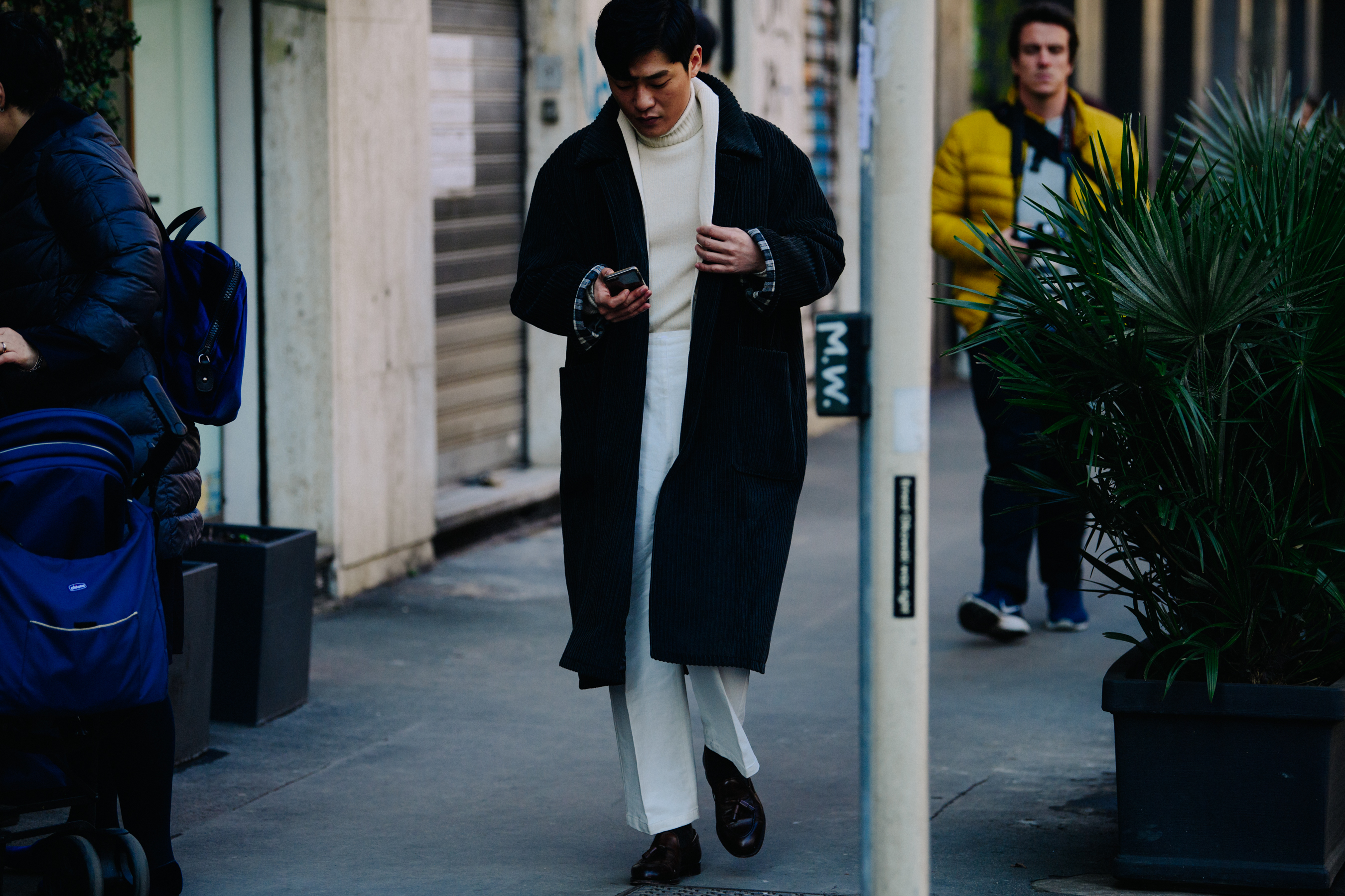 Asian man wearing black corduroy coat