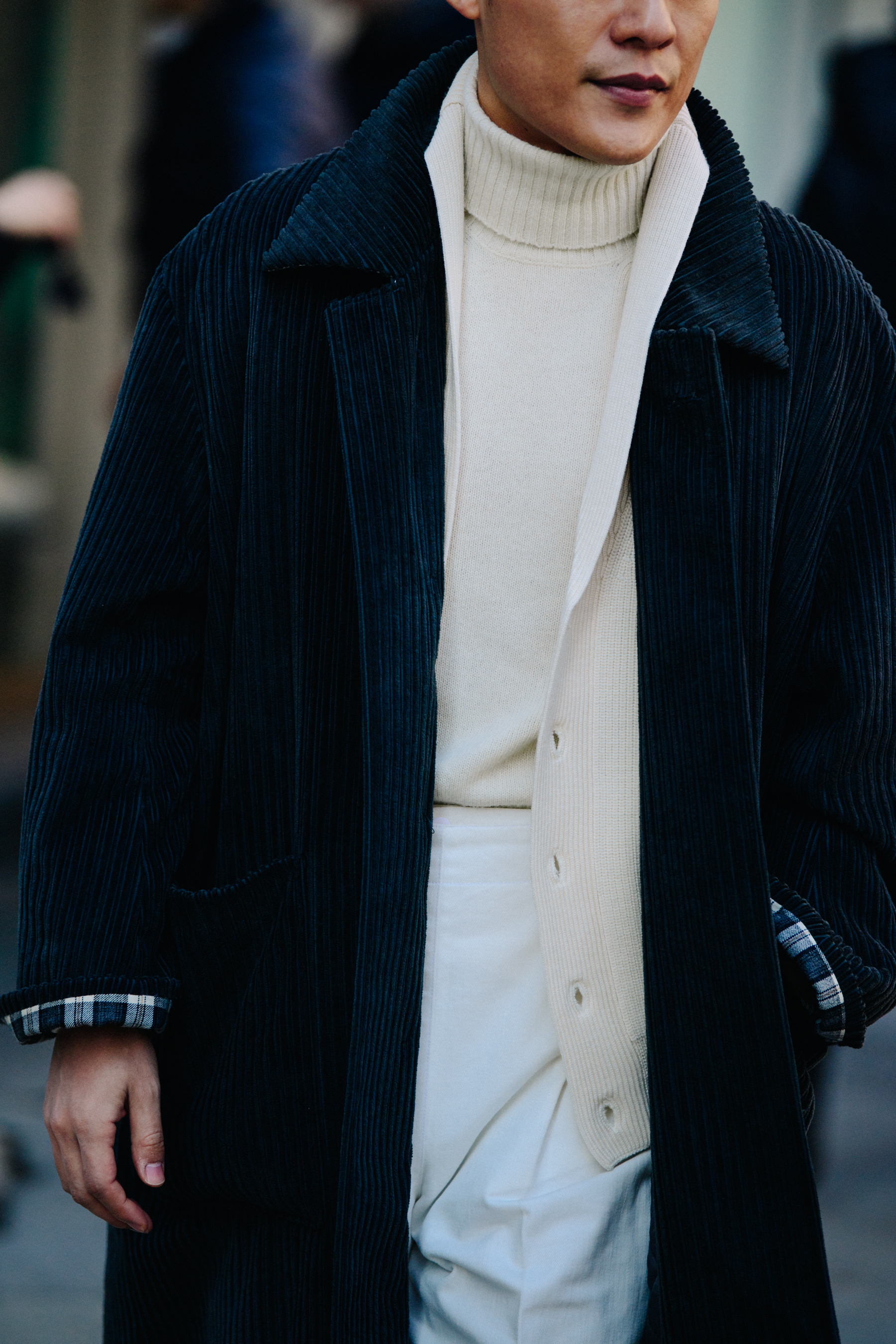 Asian man wearing black corduroy coat