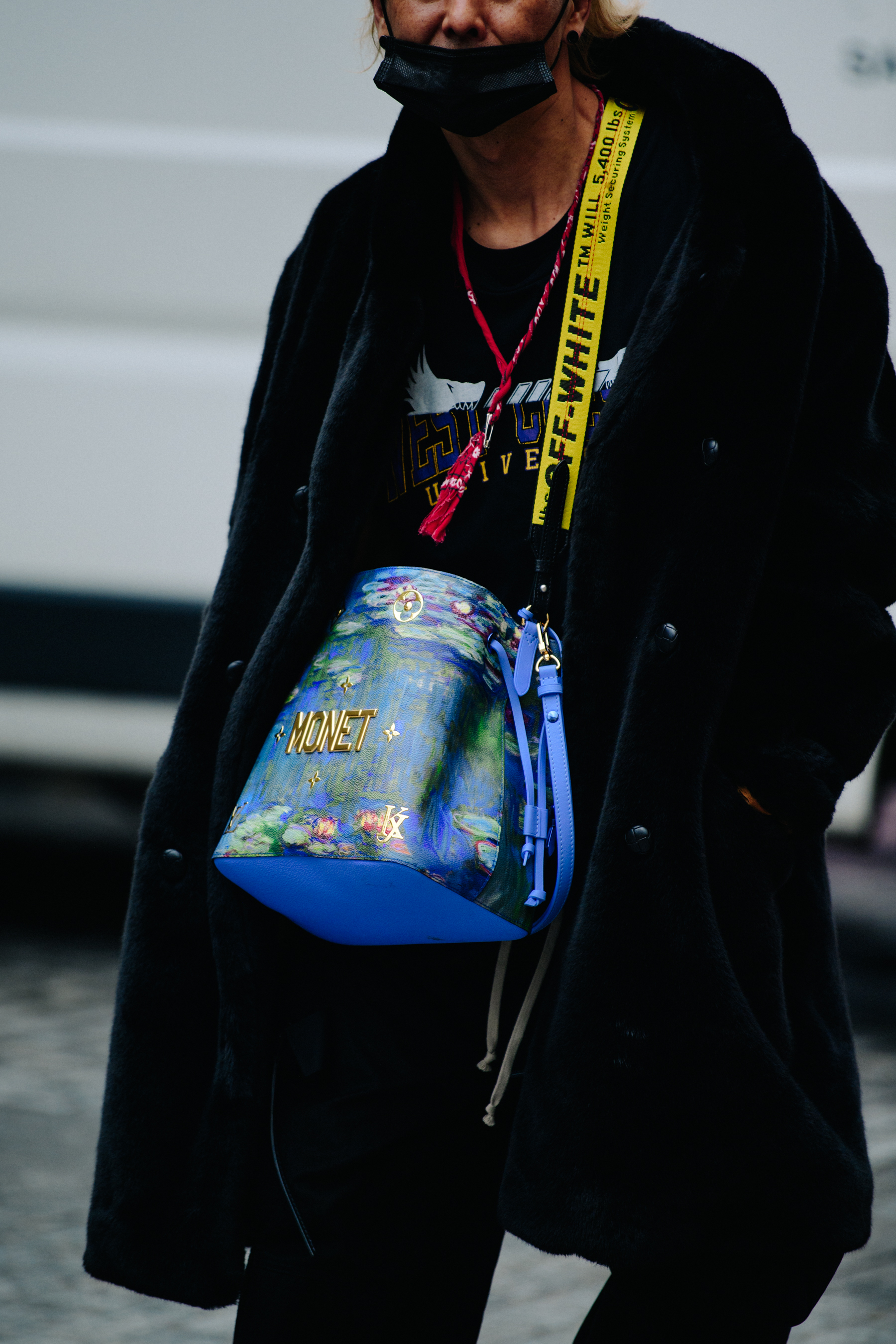 Asian man wearing Louis Vuitton bag