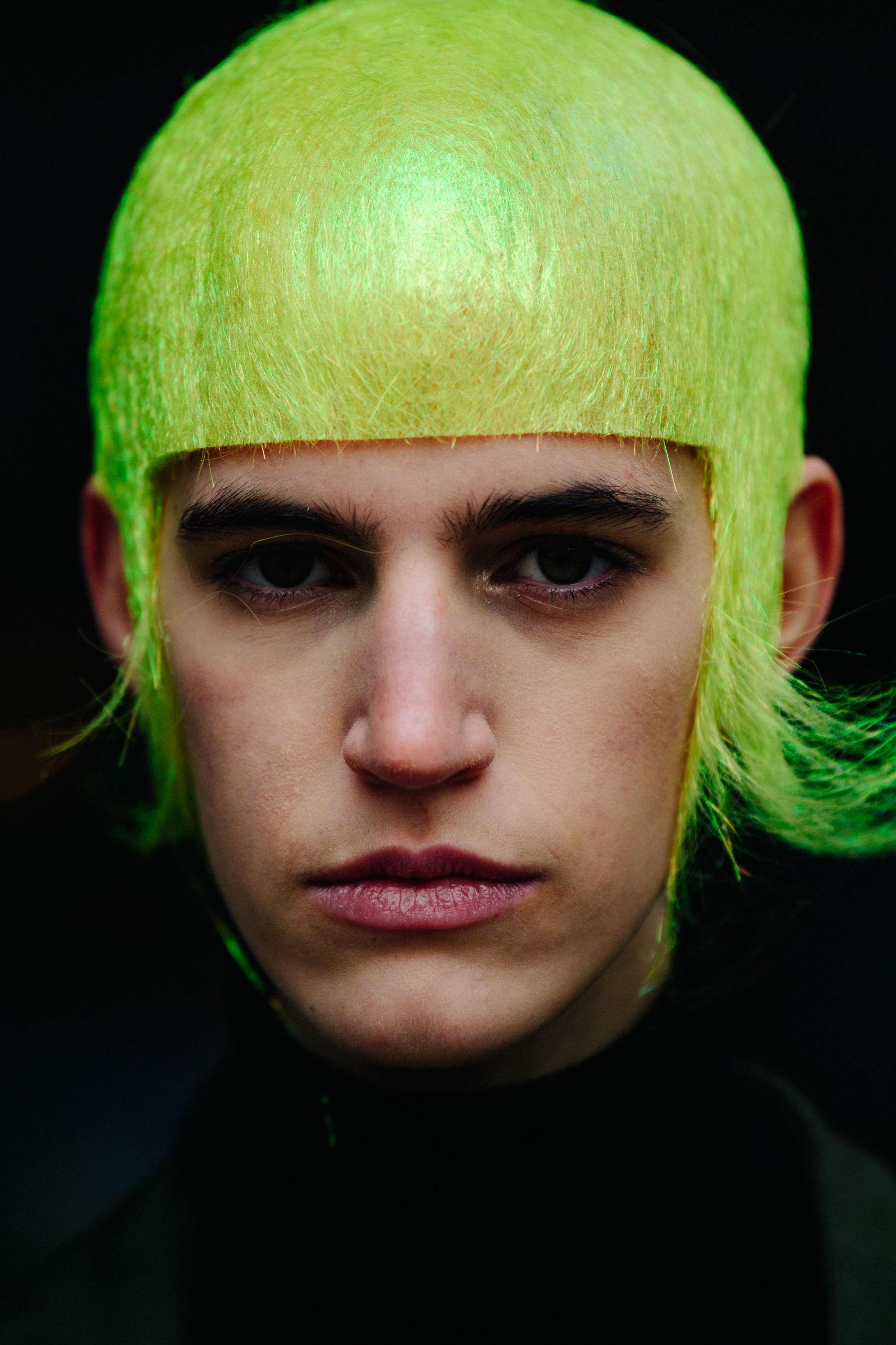 Portrait of model wearing fluorescent yellow wig