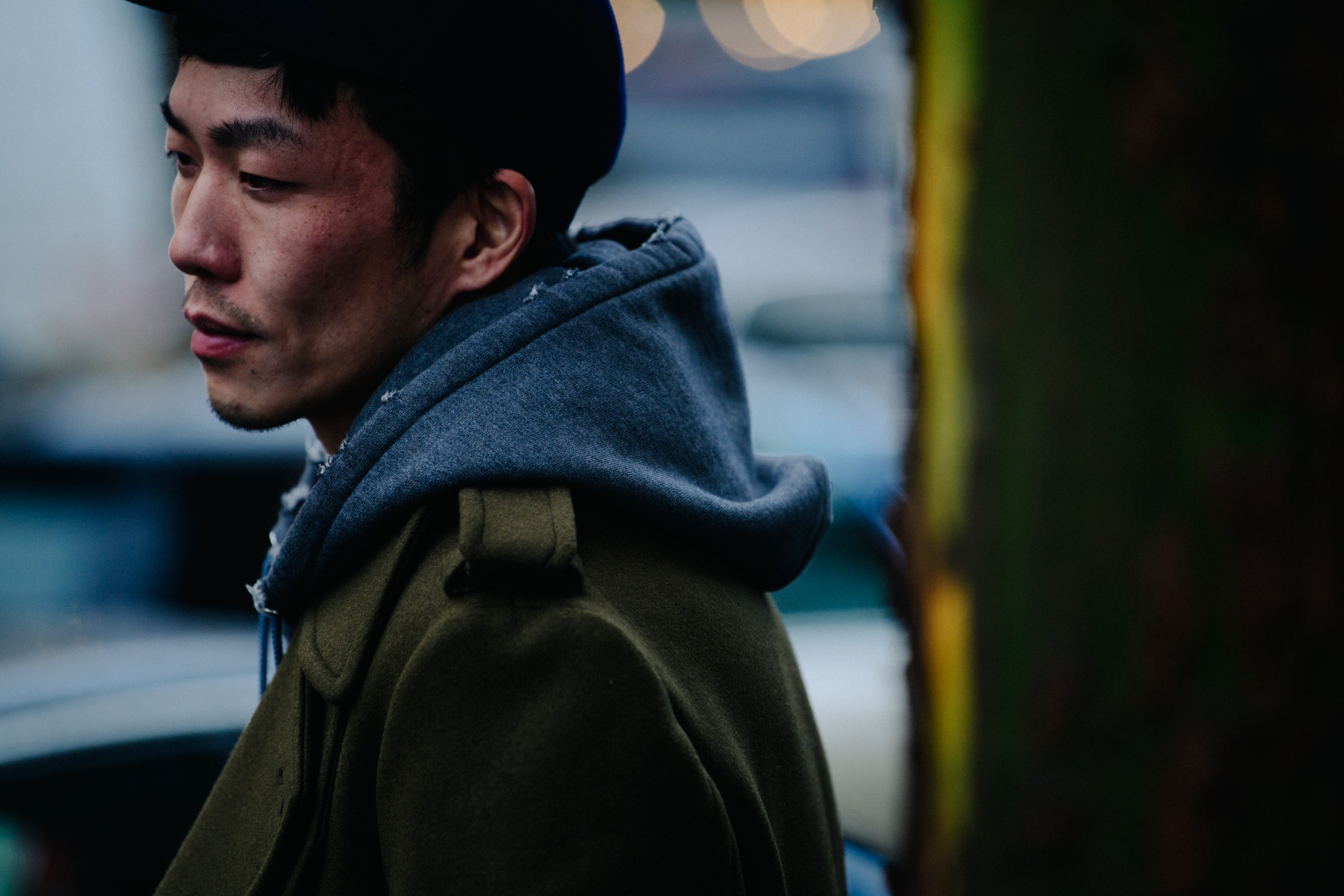 Asian man wearing green jacket