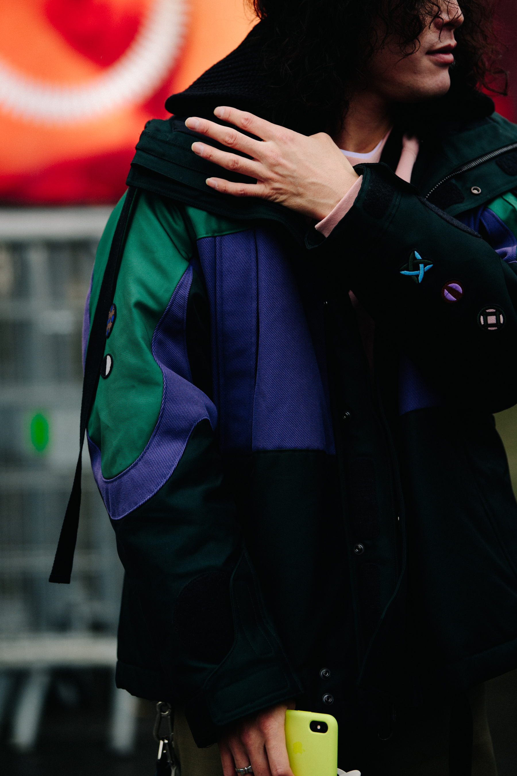 Japanese man wearing purple and green coat